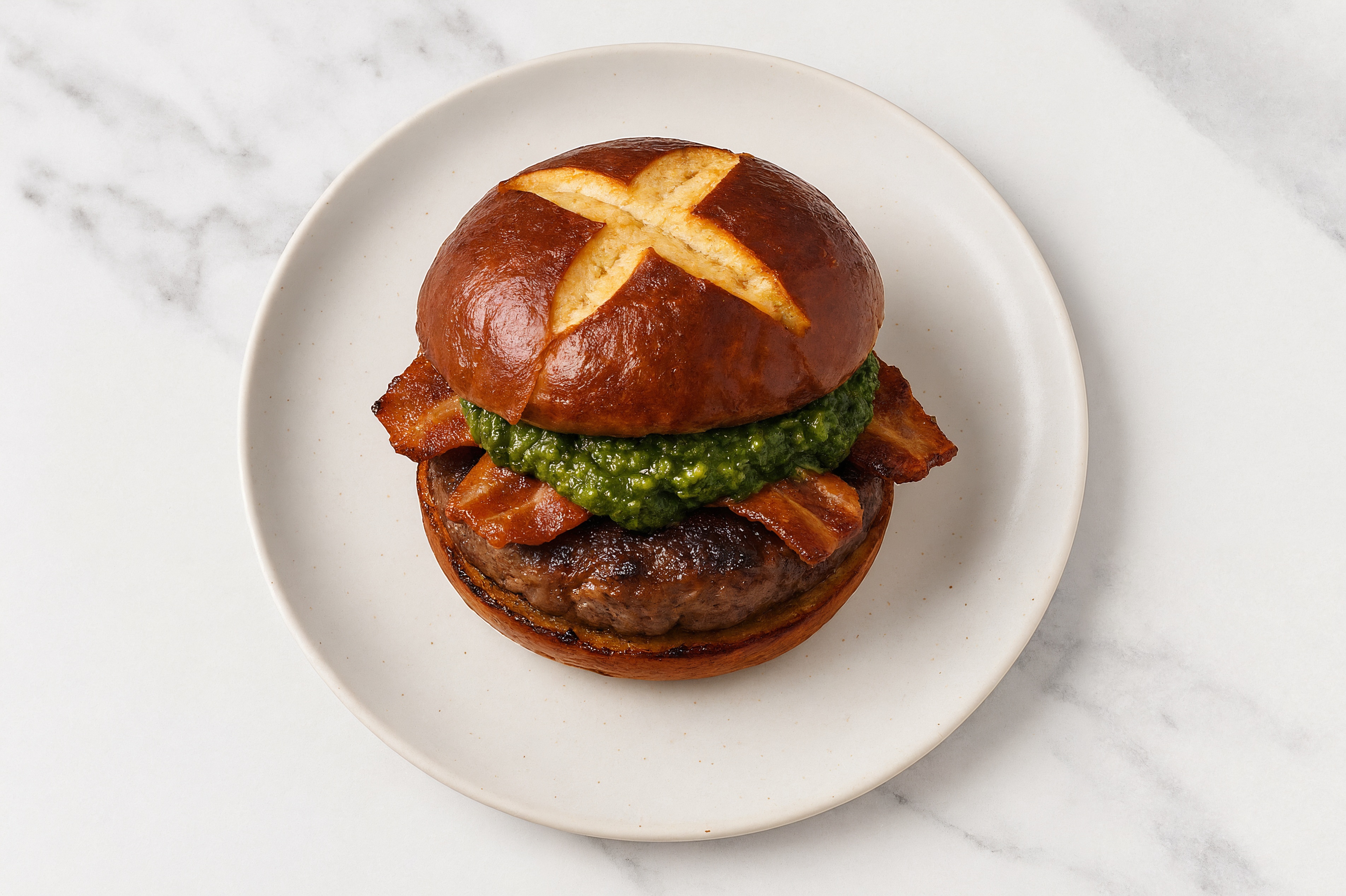 Bison Burger on Pretzel with Spinach Pesto & Applewood Smoked Pork Bacon