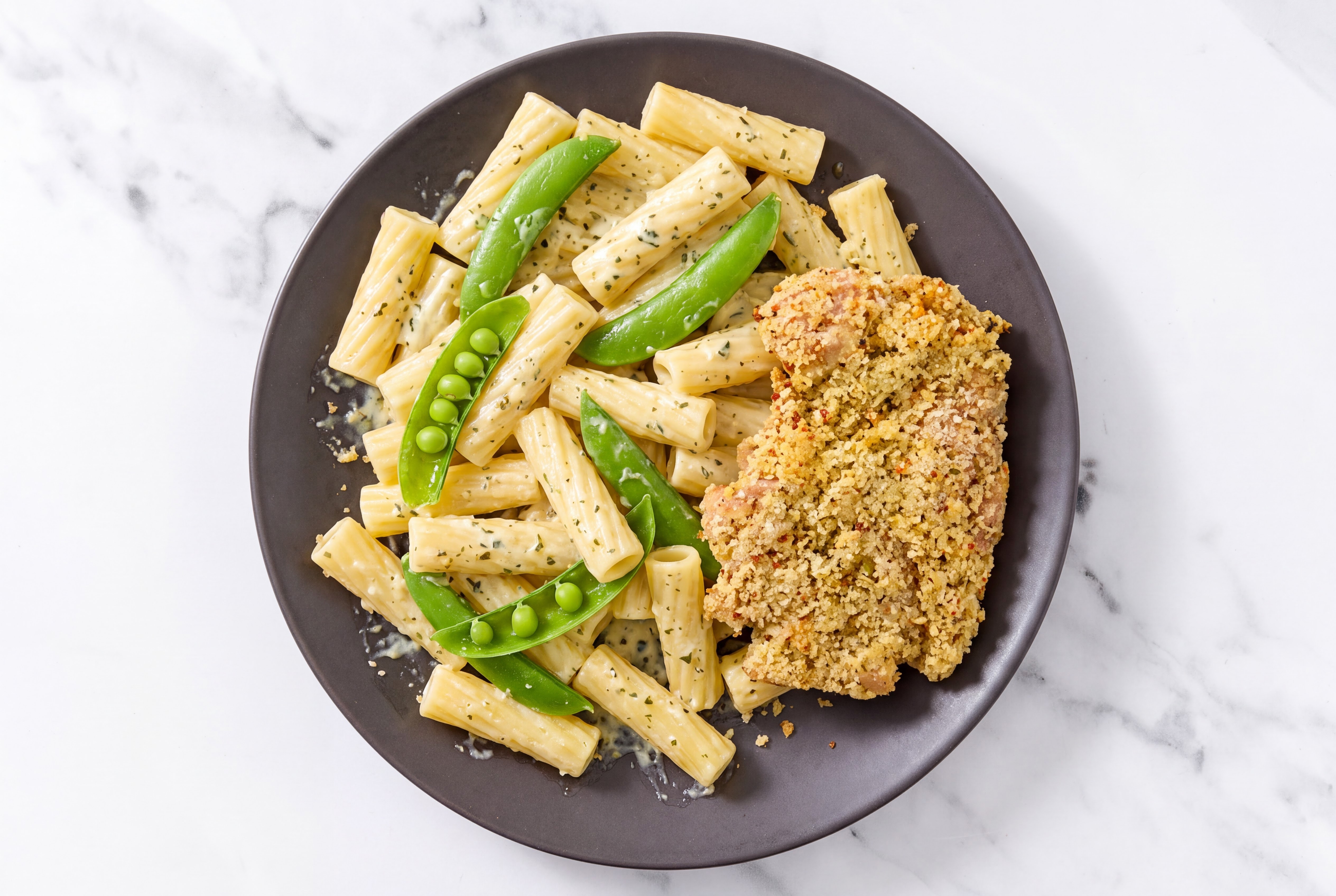 Crispy Garlic Chicken over Creamy Rigatoni with Snap Peas