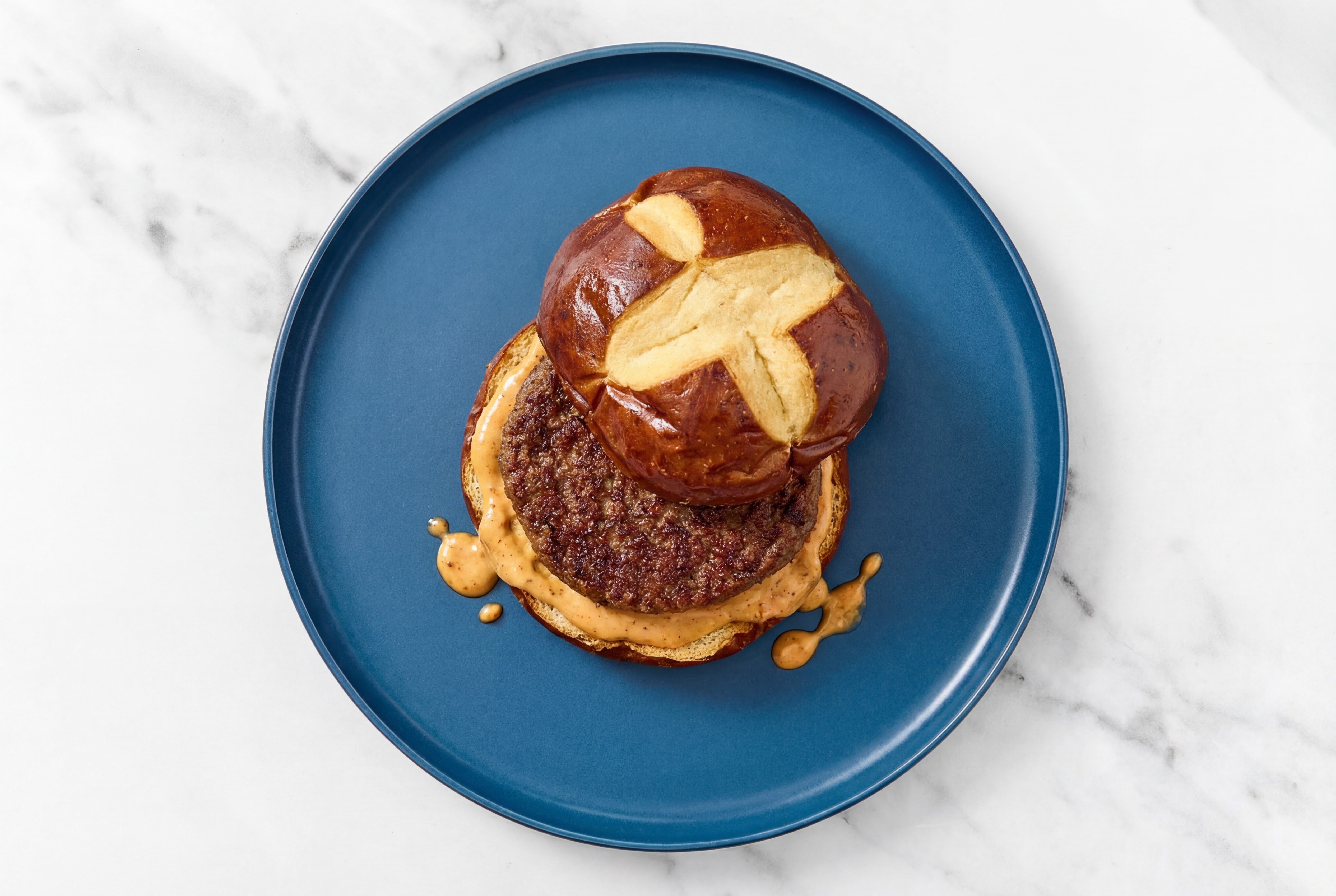 Classic Hamburger on a Pretzel Bun with Creamy Smoky BBQ with Fully Cooked Beef Burgers