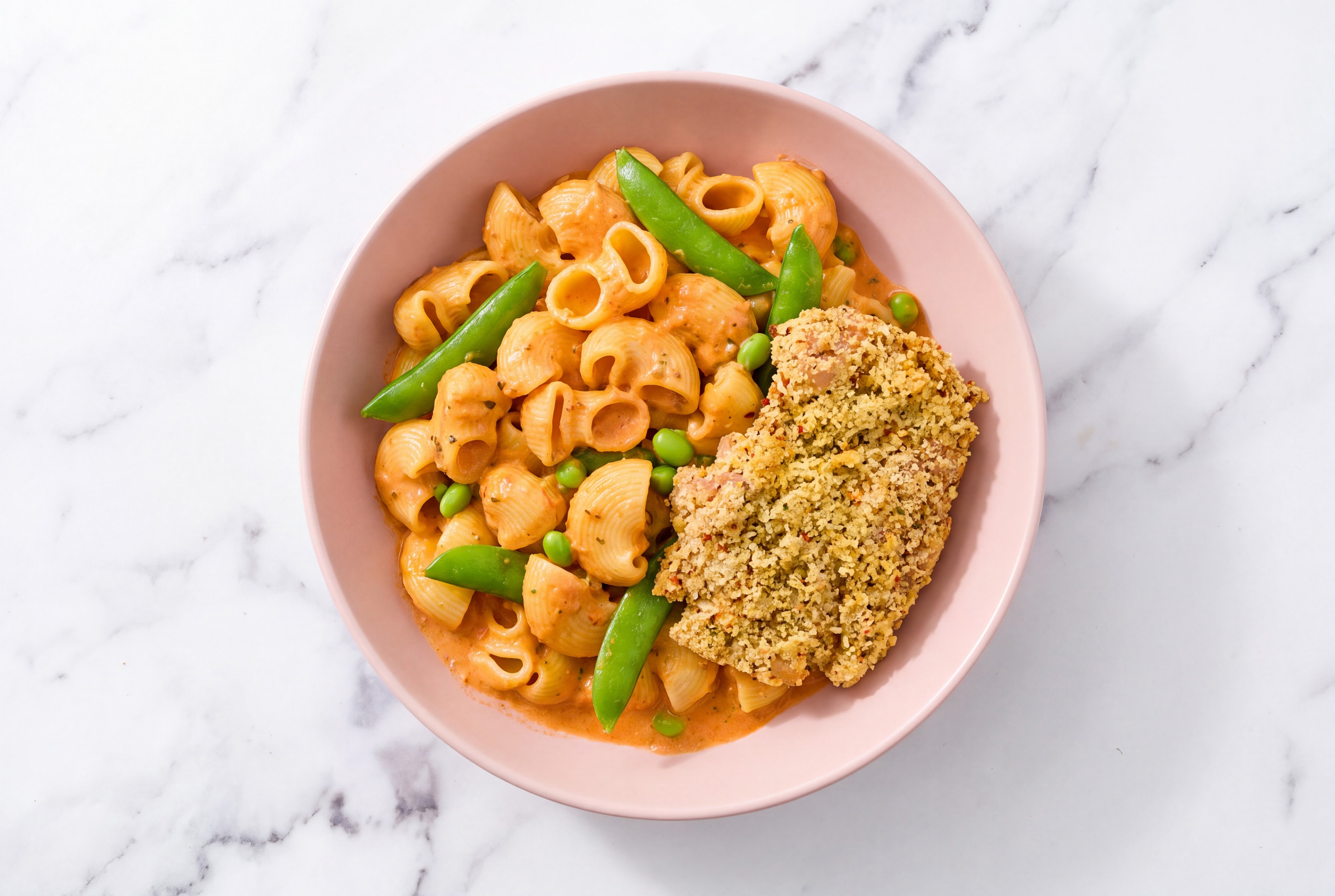 Crispy Garlic Chicken over Creamy Vodka Chiocciole Pasta with Snap Peas