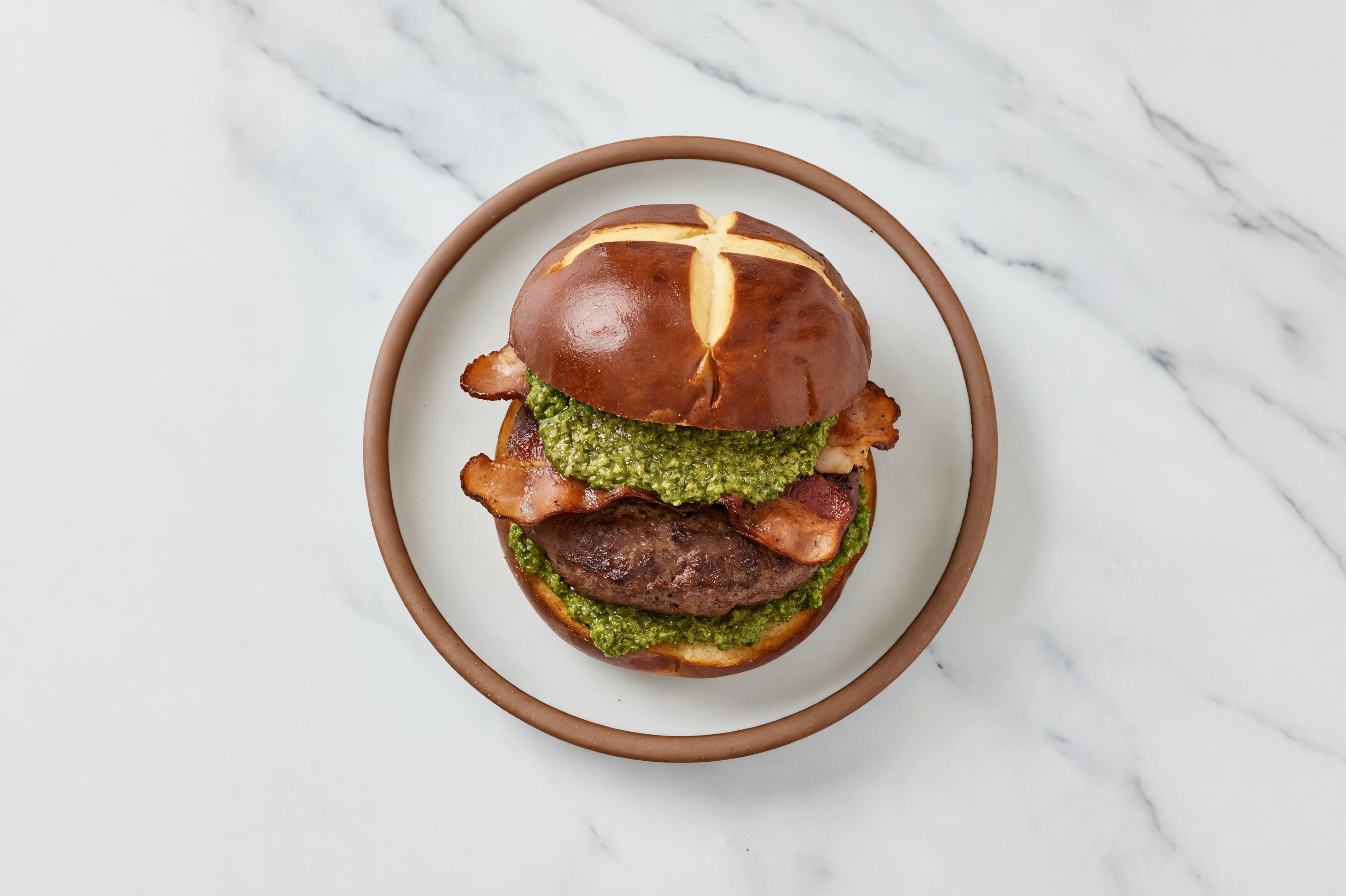 Beef Burger on Pretzel with Spinach Pesto & Turkey Bacon