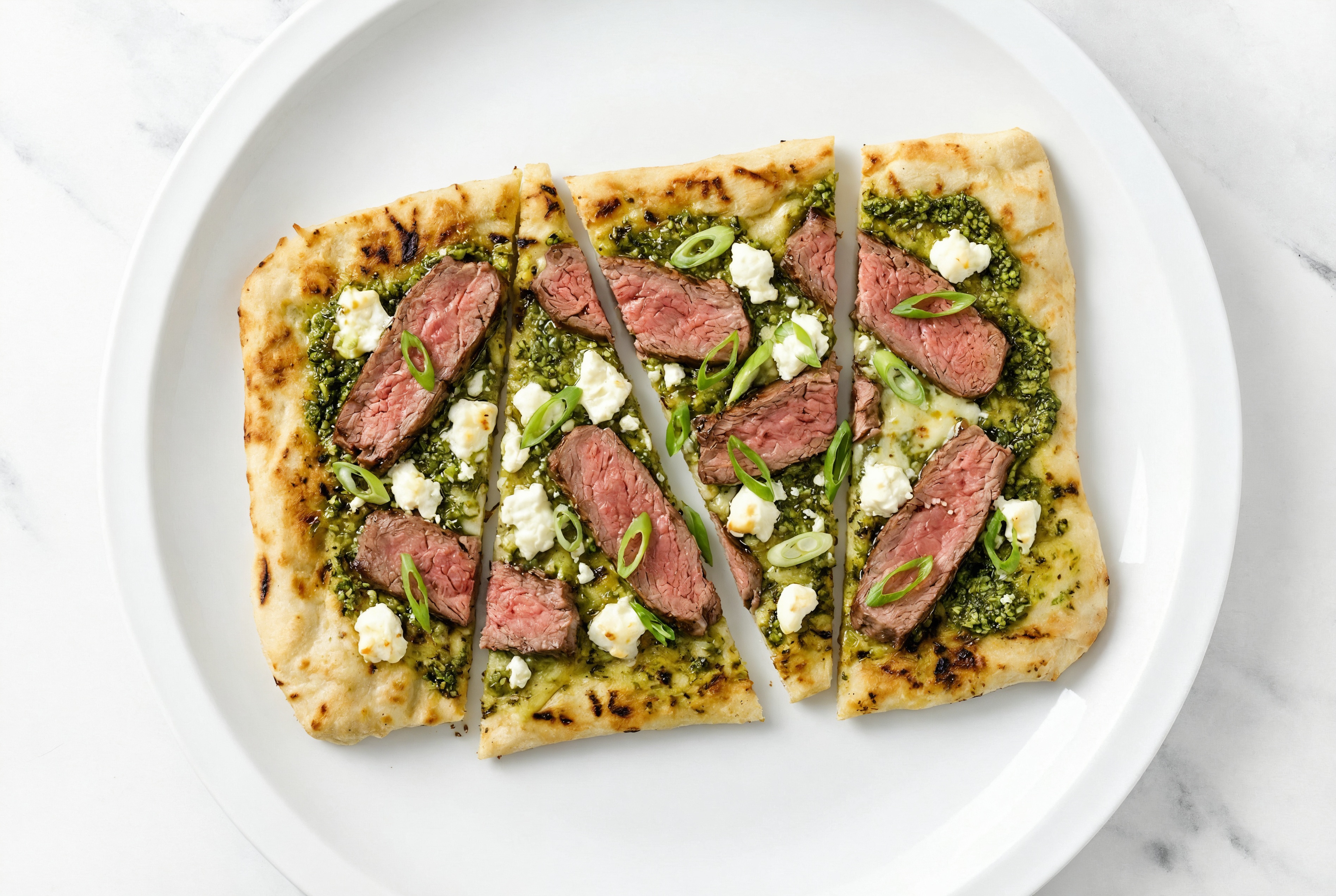 Pesto Seasoned Sirloin Grilled Pizza with Sheep Cheese + Fresh Scallions