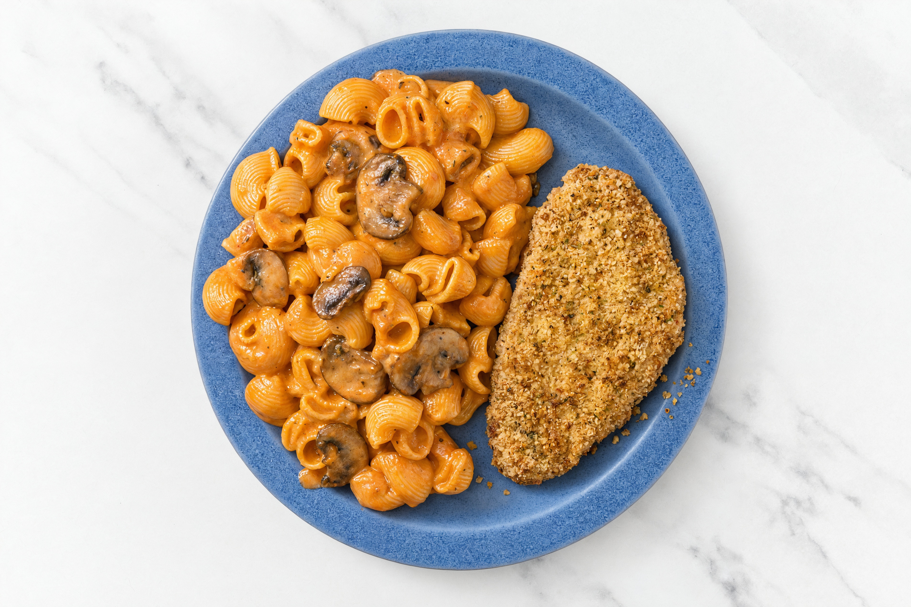 Crispy Garlic Chicken over Creamy Vodka Chiocciole Pasta with Baby Bella Mushrooms