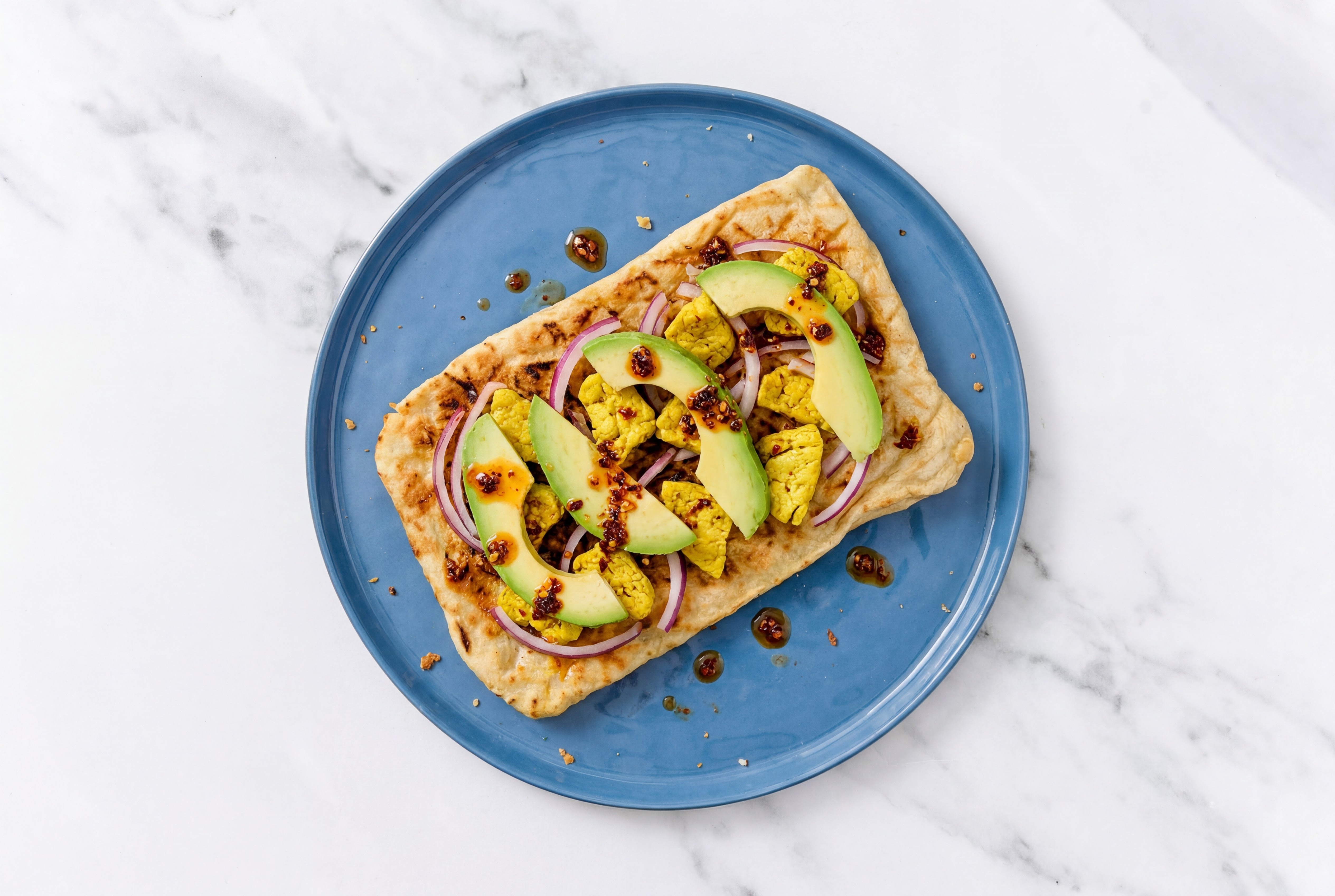 Lemongrass Tofu, Red Onion + Chili Crisp Pizza with Avocado