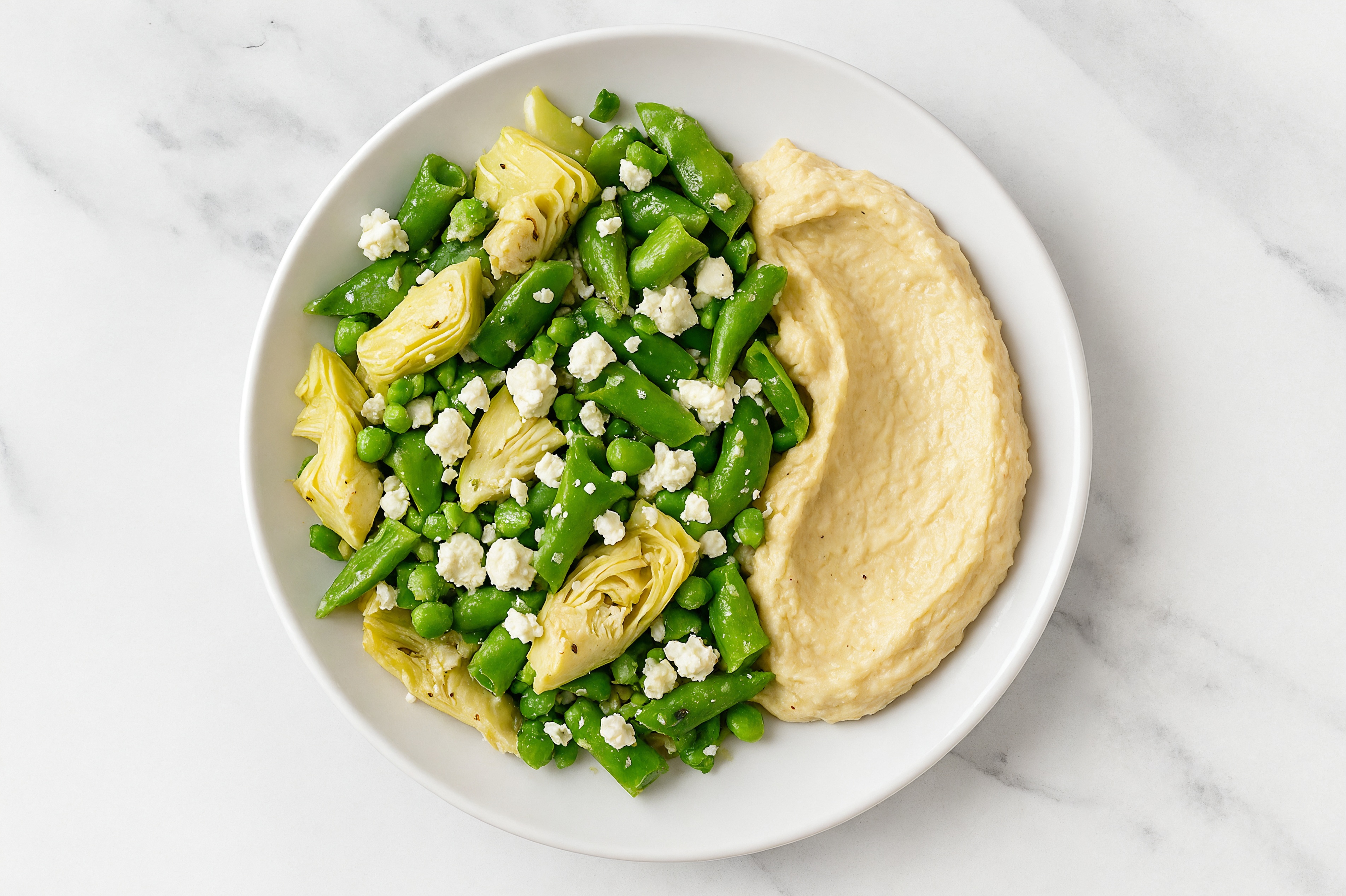 Crumbled Chevre Artichoke Snap Pea Bowl over Lemon Garlic Hummus
