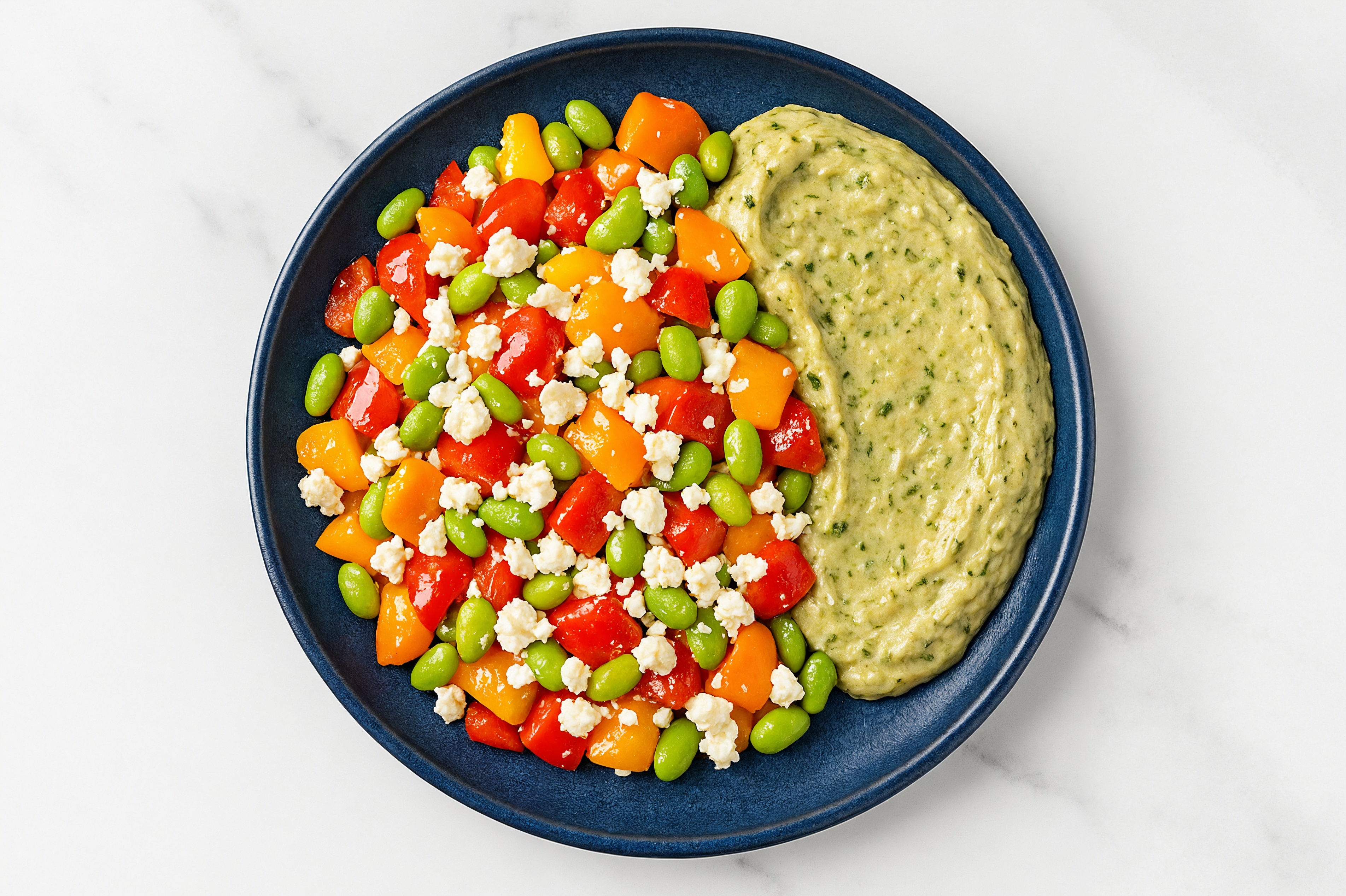 Crumbled Chevre Sweet Pepper Edamame Bowl over Spinach Artichoke Dip