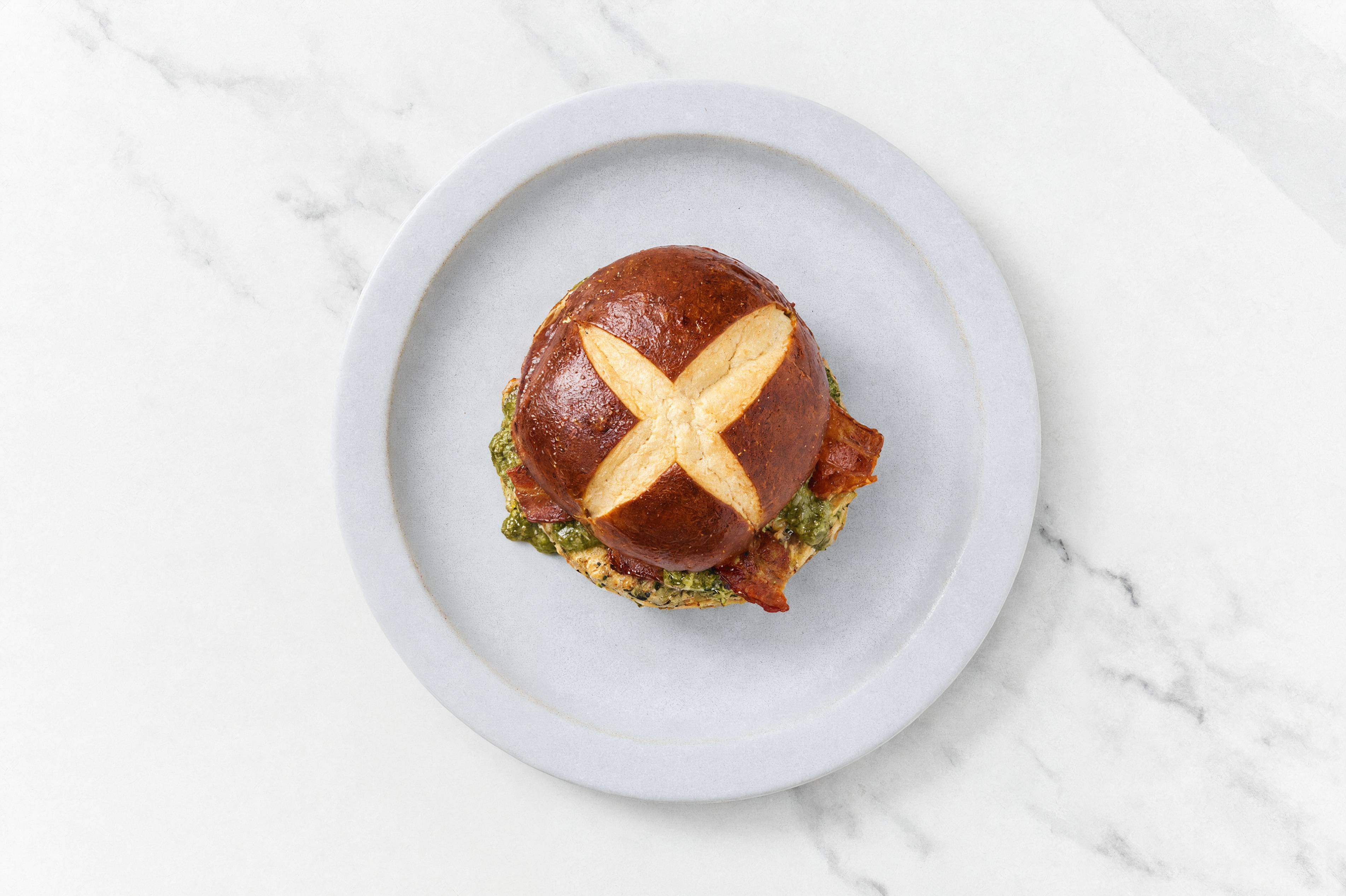 Garlic Turkey Burger on Pretzel with Spinach Pesto & Turkey Bacon