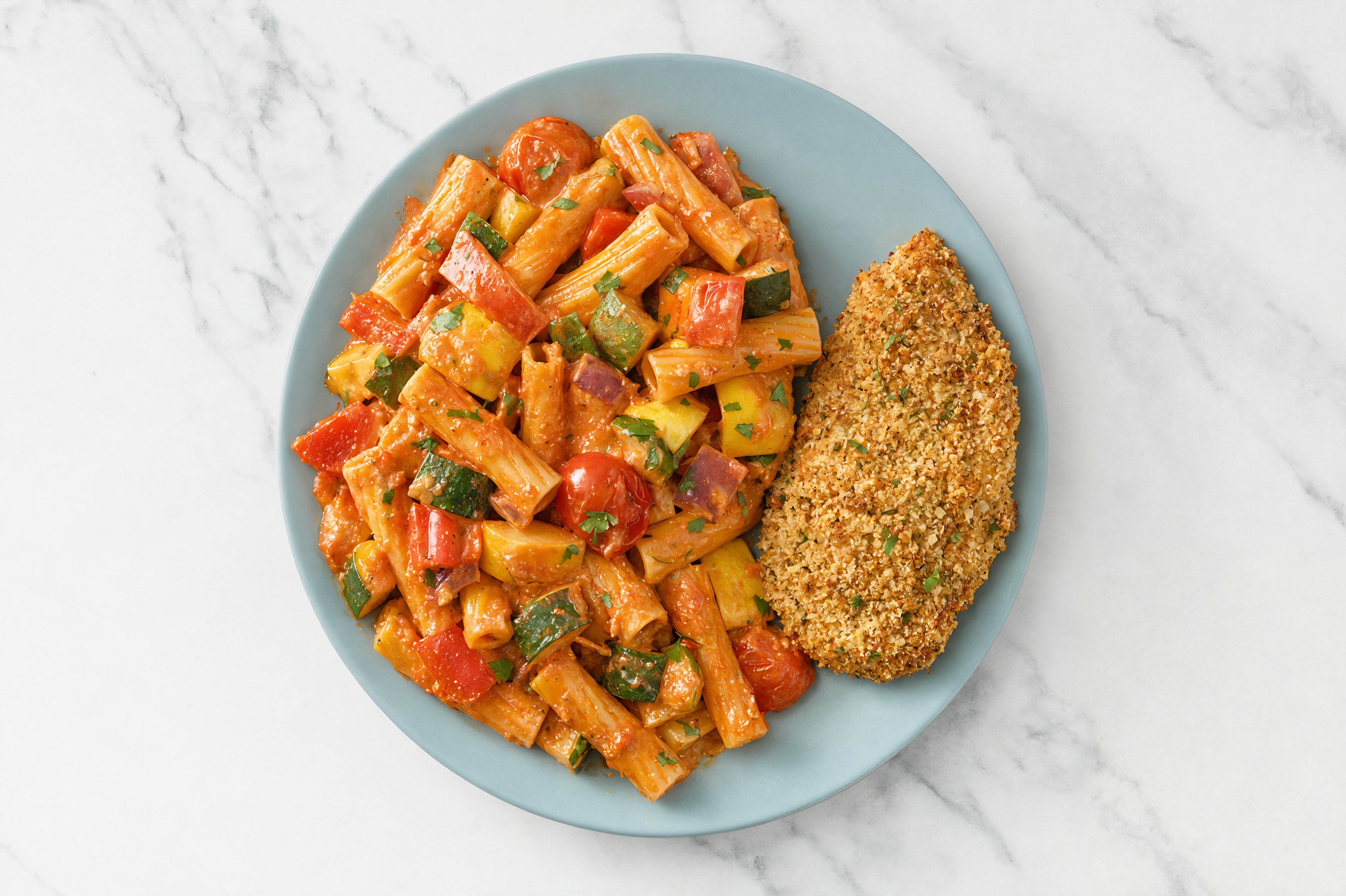 Crispy Garlic Chicken over Creamy Vodka Rigatoni with Mixed Veggies