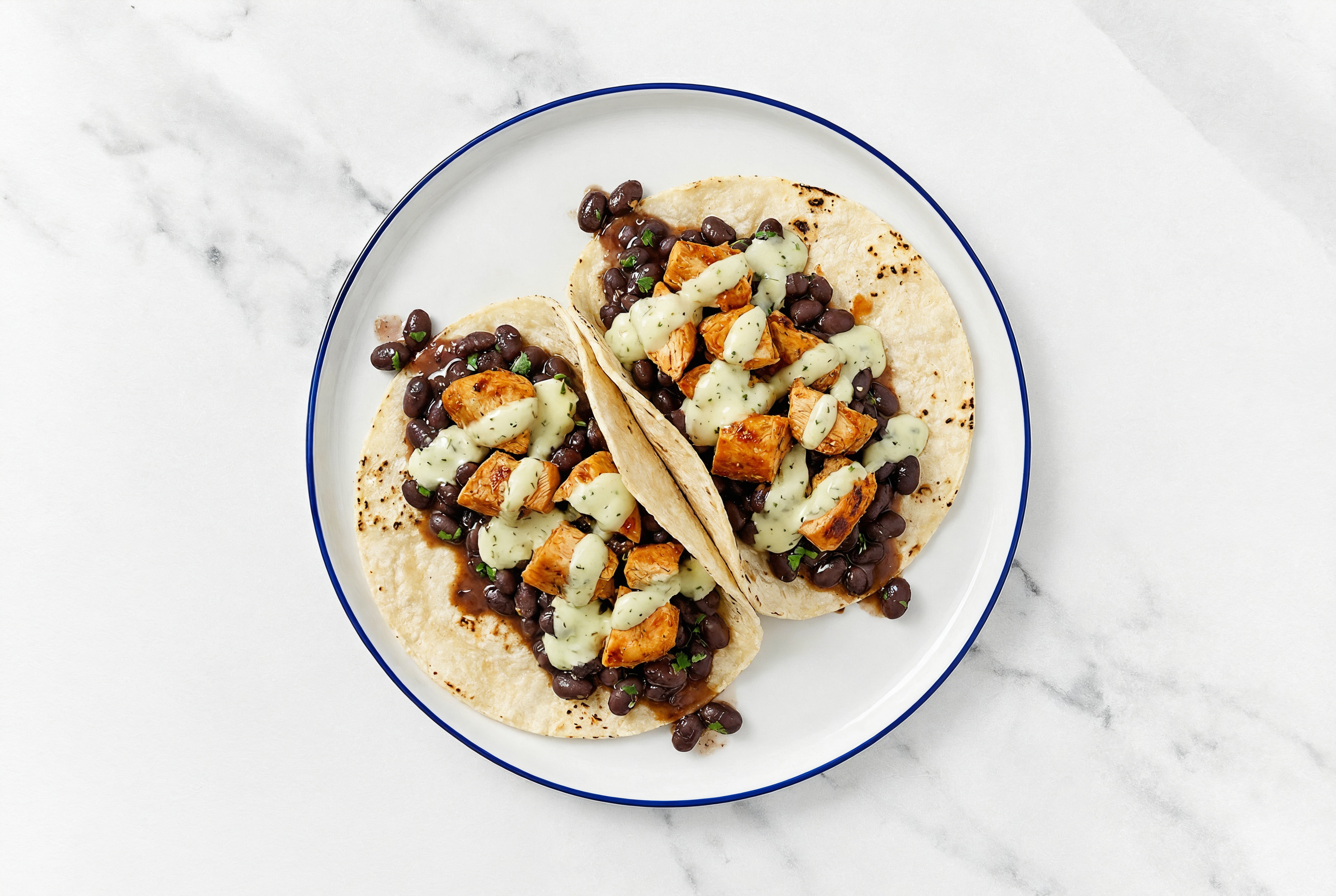 Hearty Chipotle Chicken Tacos with Jalapeño Crema & Spiced Beans