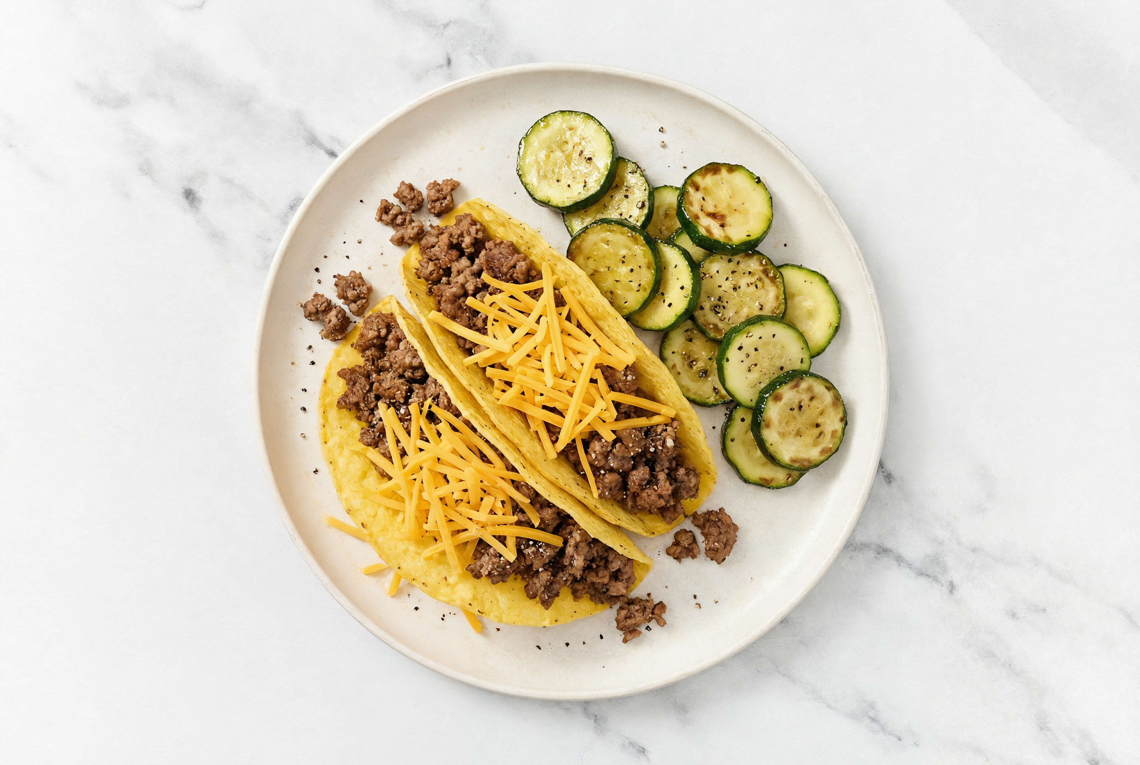 Herby Cheesy Ground Beef Tacos + Zucchini with Shredded Sharp Cheddar Cheese