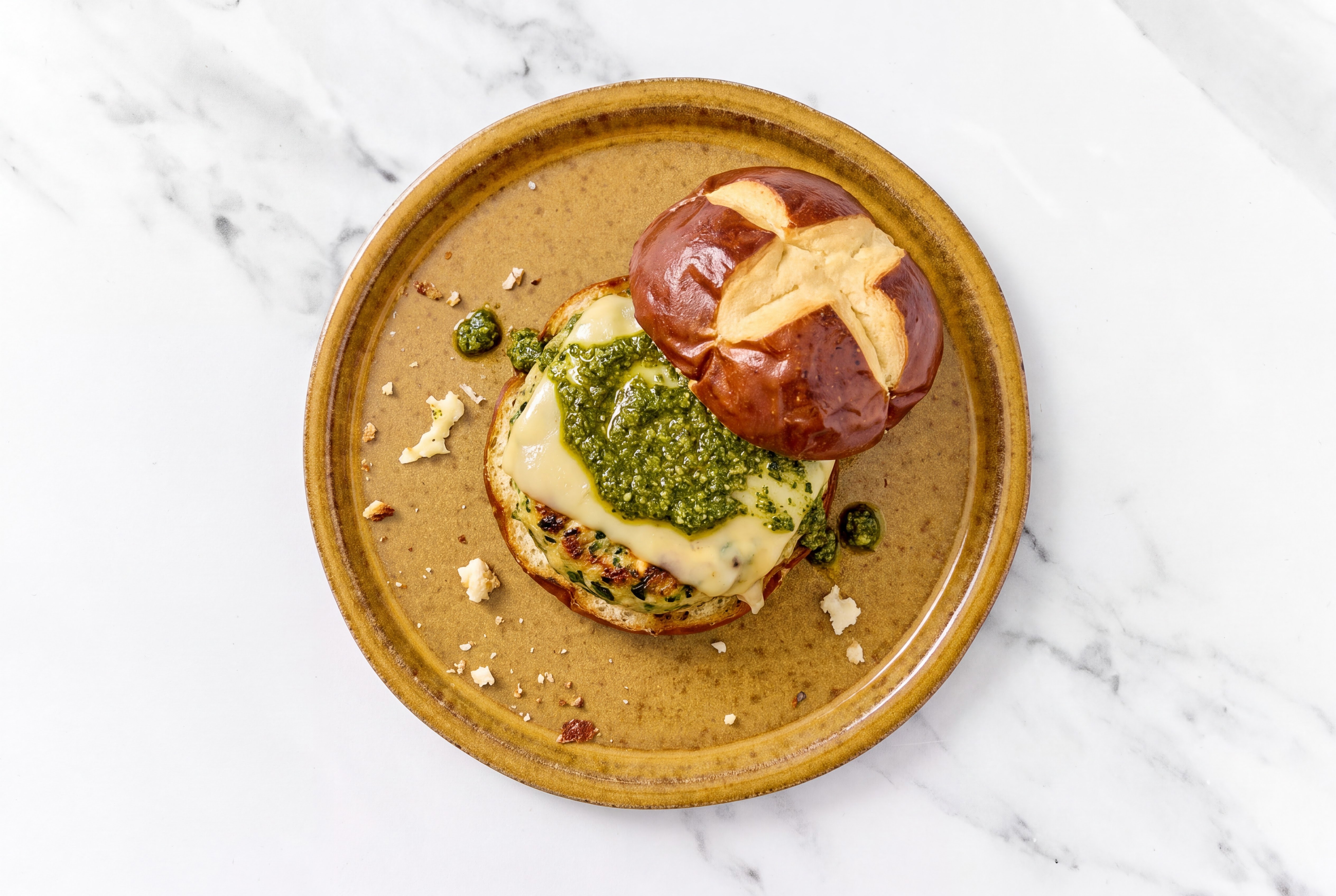 Garlic Turkey Burger on Pretzel with Spinach Pesto & Gouda