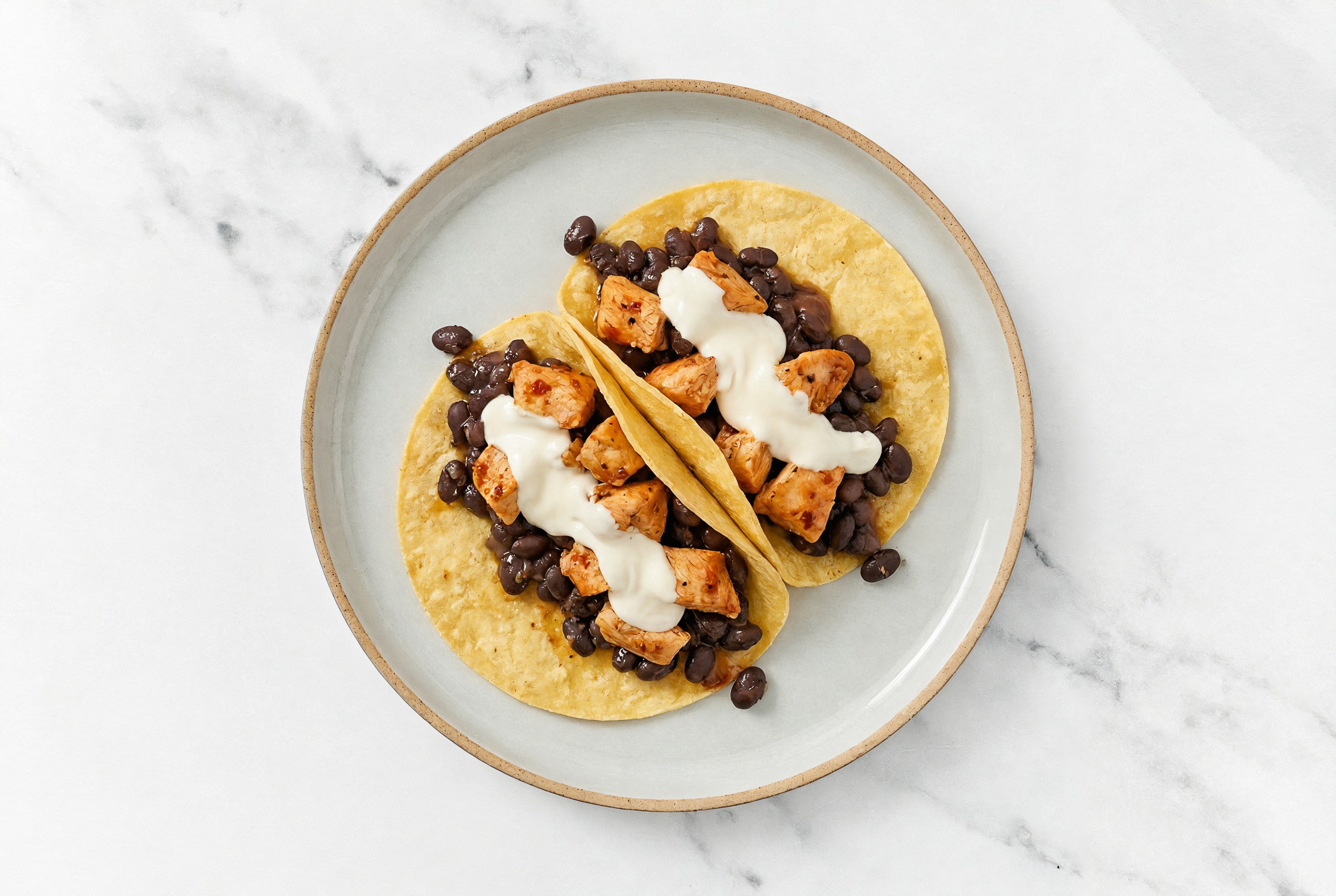 Herby Chipotle Chicken Tacos with Crema & Spiced Beans