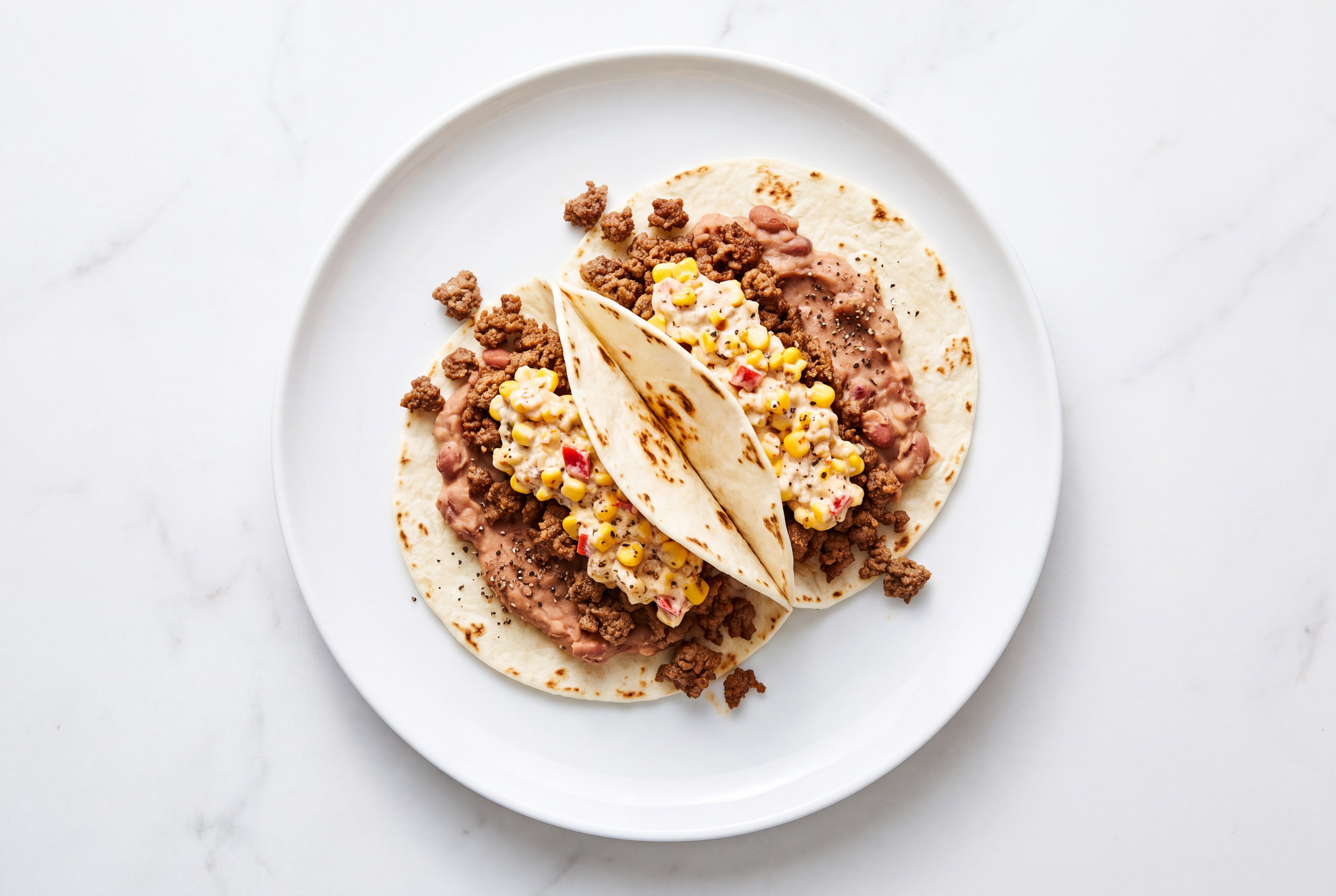 Ground 93/7 Lean Beef Tacos with Street Corn Sauce & Refried Red Beans