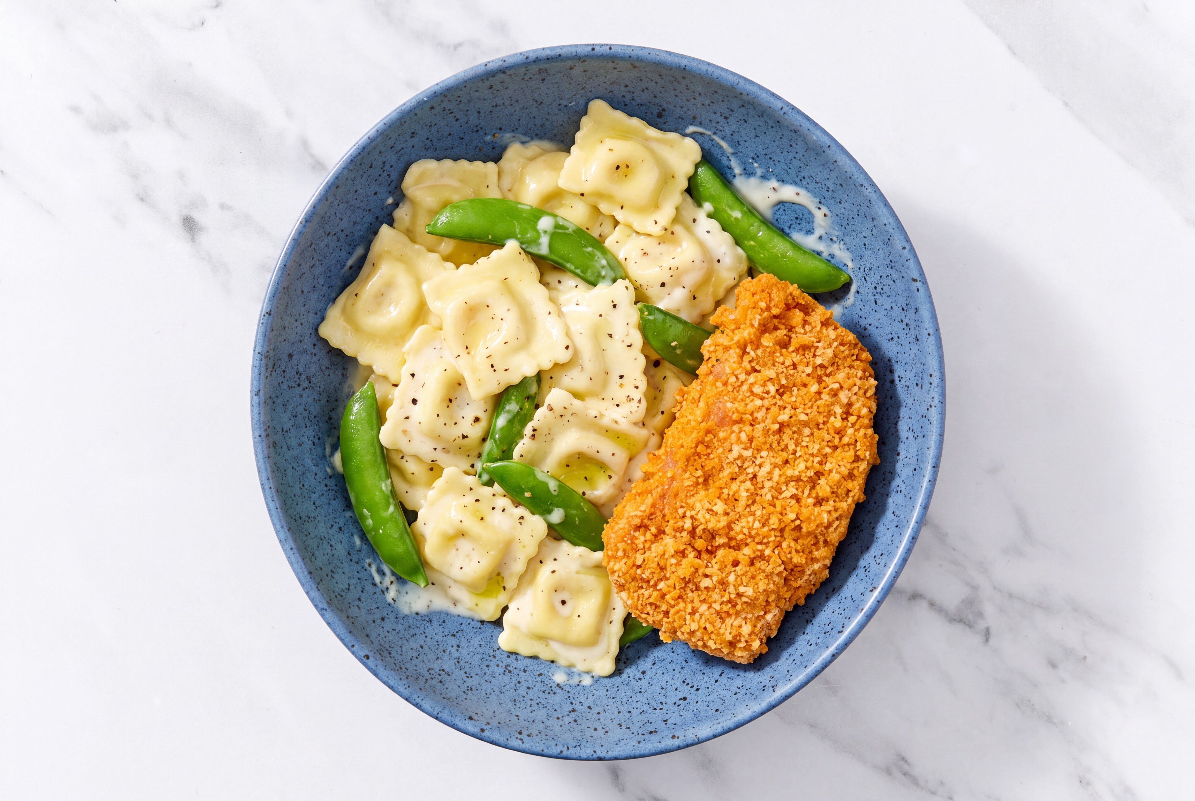 Crispy Hot Honey Chicken over Alfredo Ravioli with Snap Peas