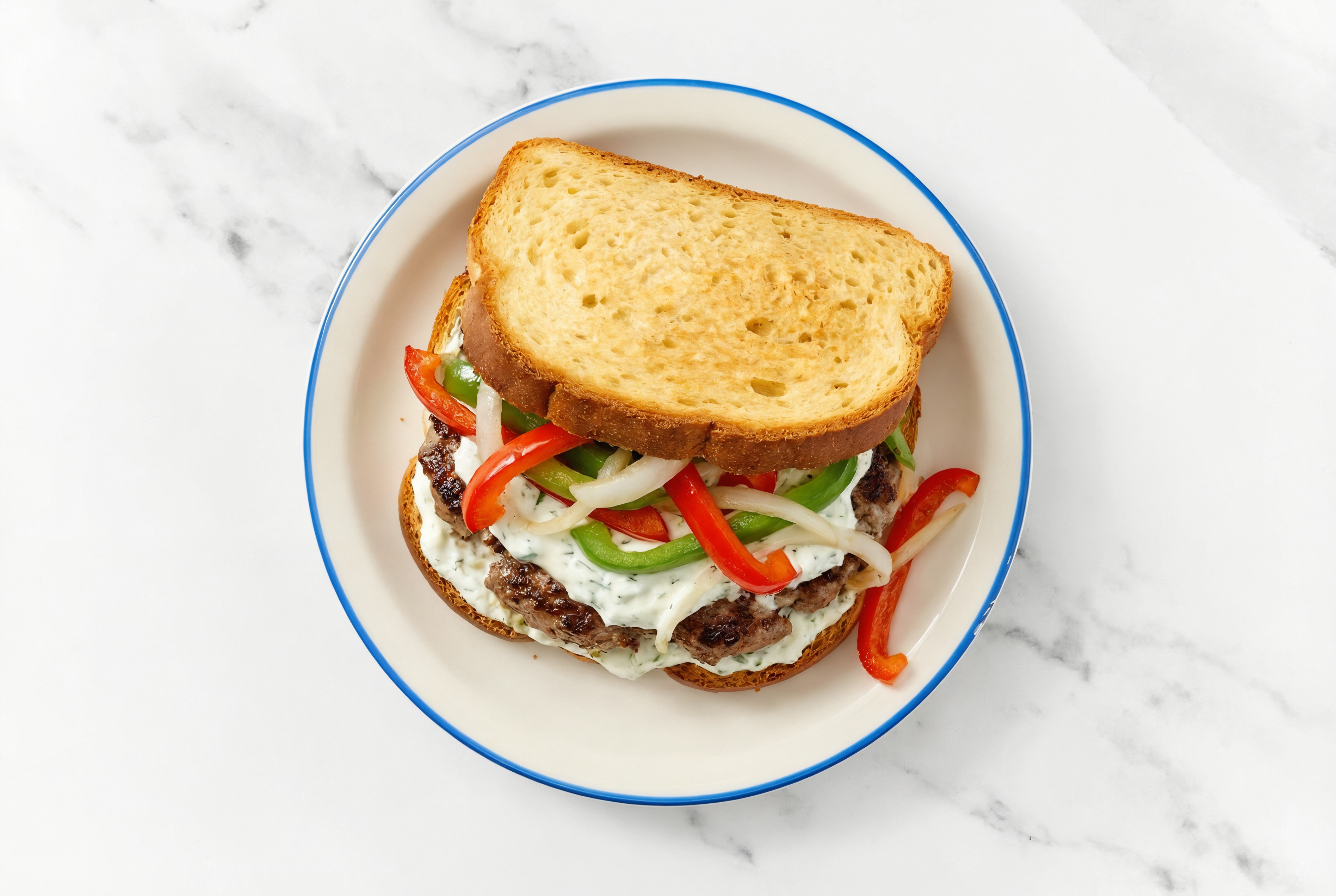 Onion + Pepper Wagyu Beef Burger on GF Bread with Cucumber Tzatziki
