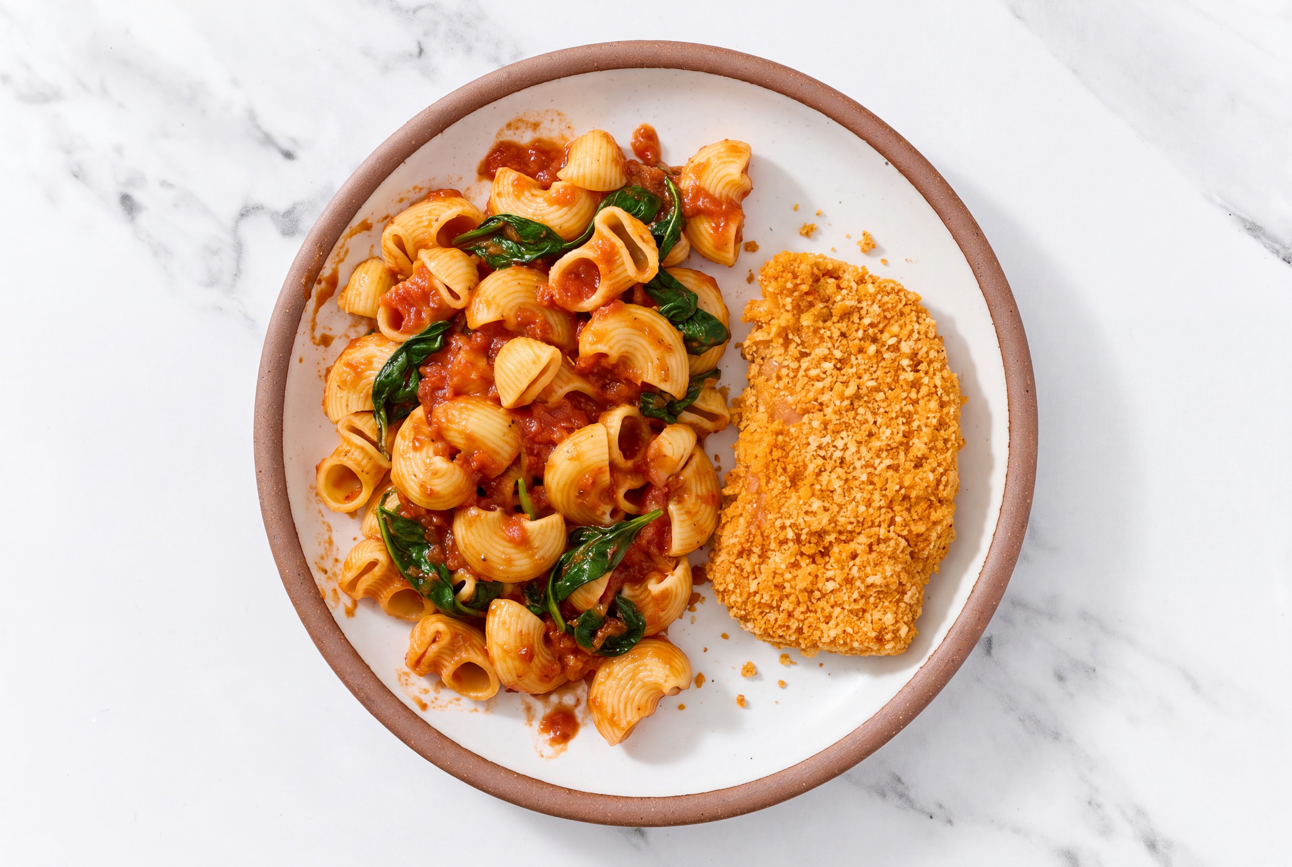 Crispy Hot Honey Chicken over Marinara Chiocciole Pasta with Baby Spinach
