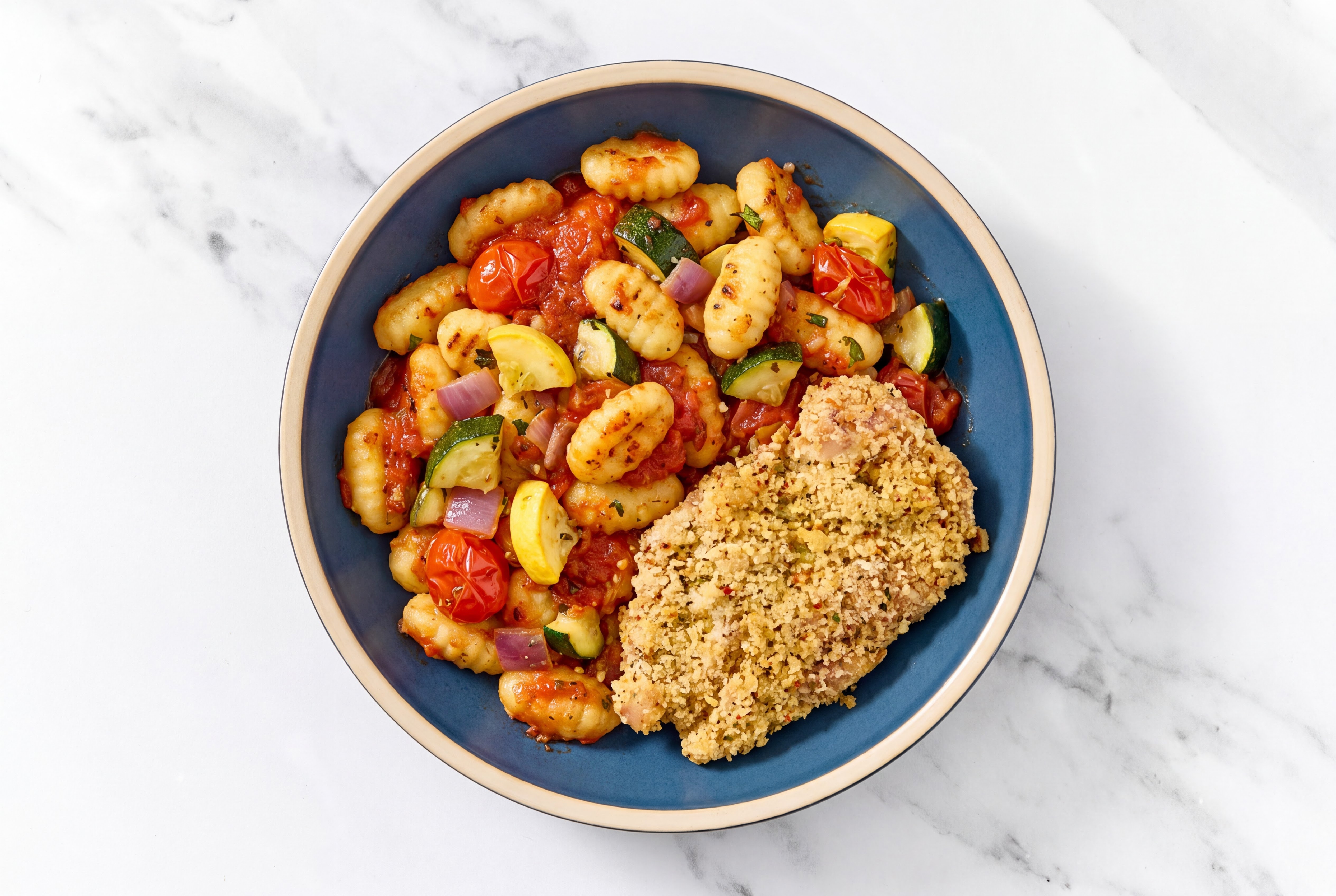 Crispy Garlic Chicken over Marinara Gnocchi with Mixed Veggies
