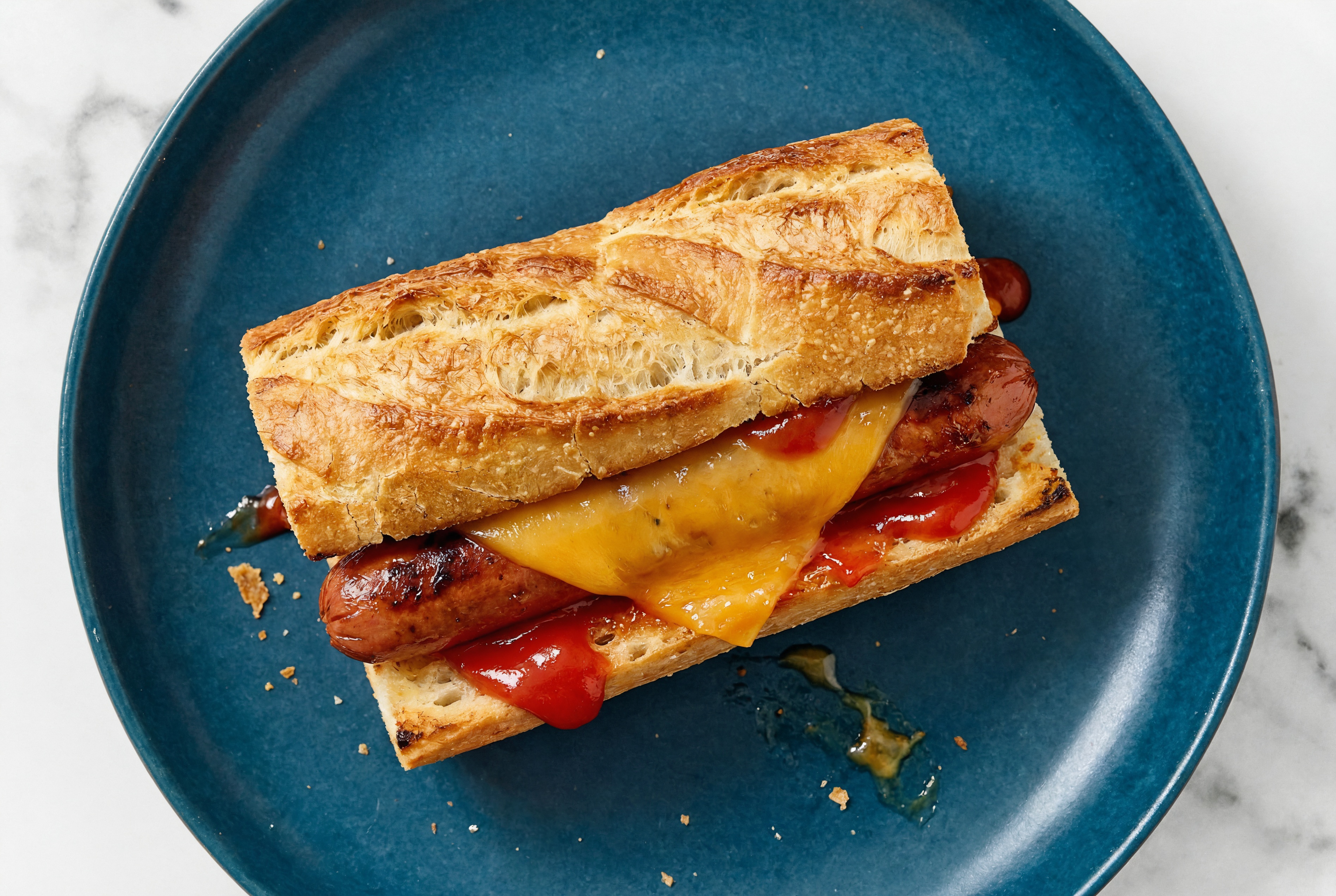 Cheddar Beef Hot Dog with Ketchup on Baguette