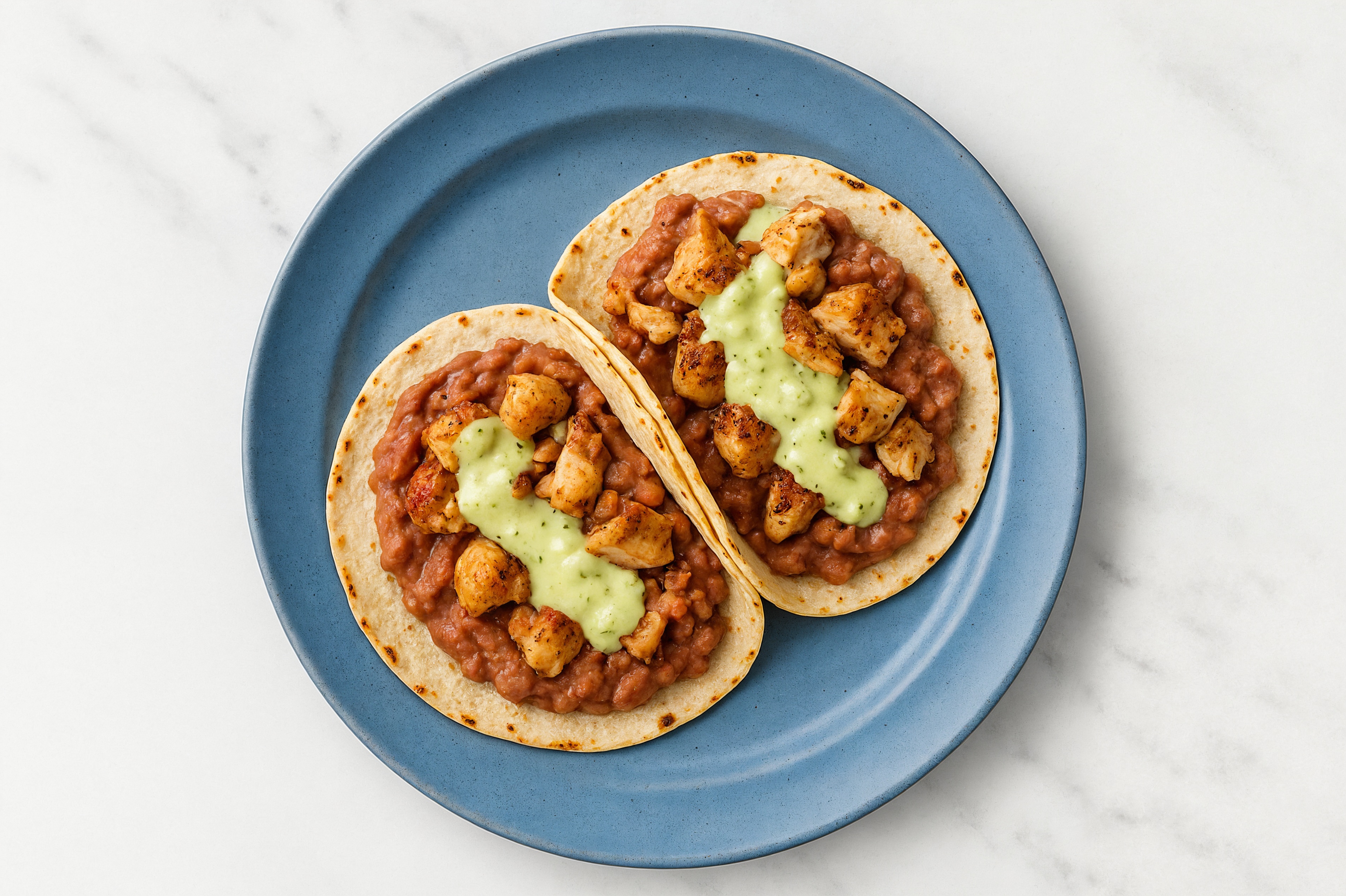 Hearty Garlic Turkey Tacos with Jalapeño Crema & Refried Red Beans
