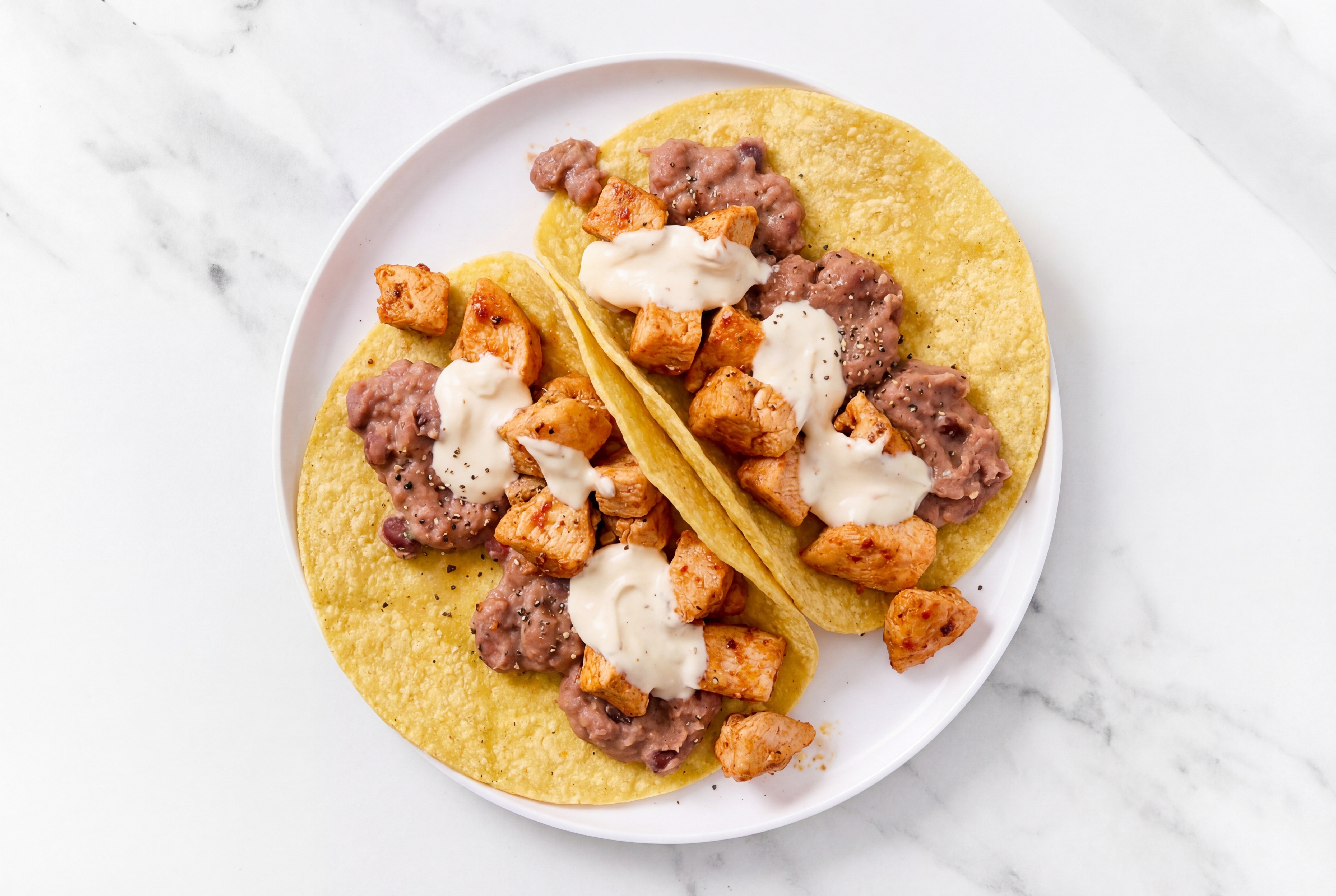 Herby Chipotle Chicken Tacos with Crema & Refried Red Beans