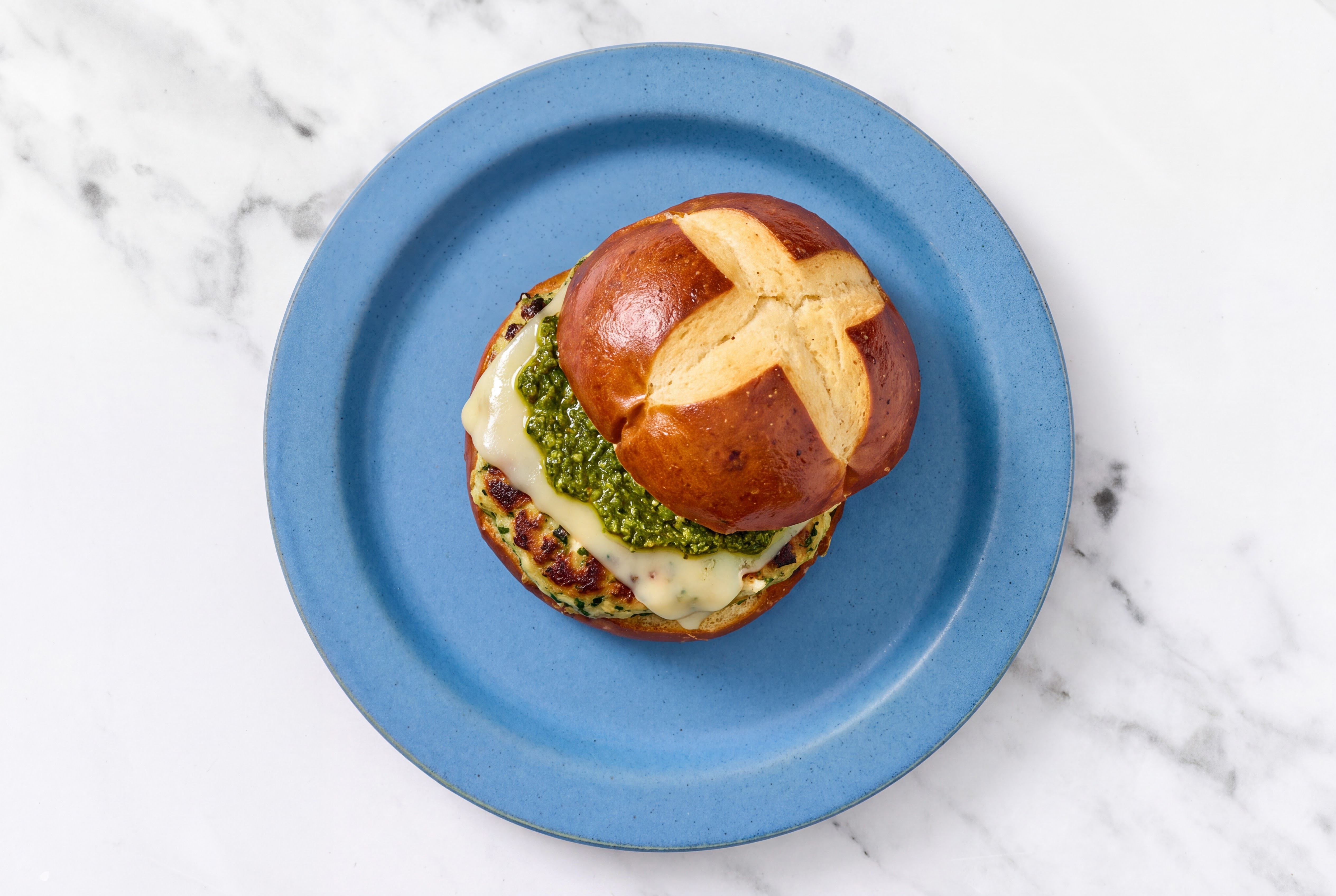 Garlic Turkey Burger on Pretzel with Spinach Pesto & Swiss