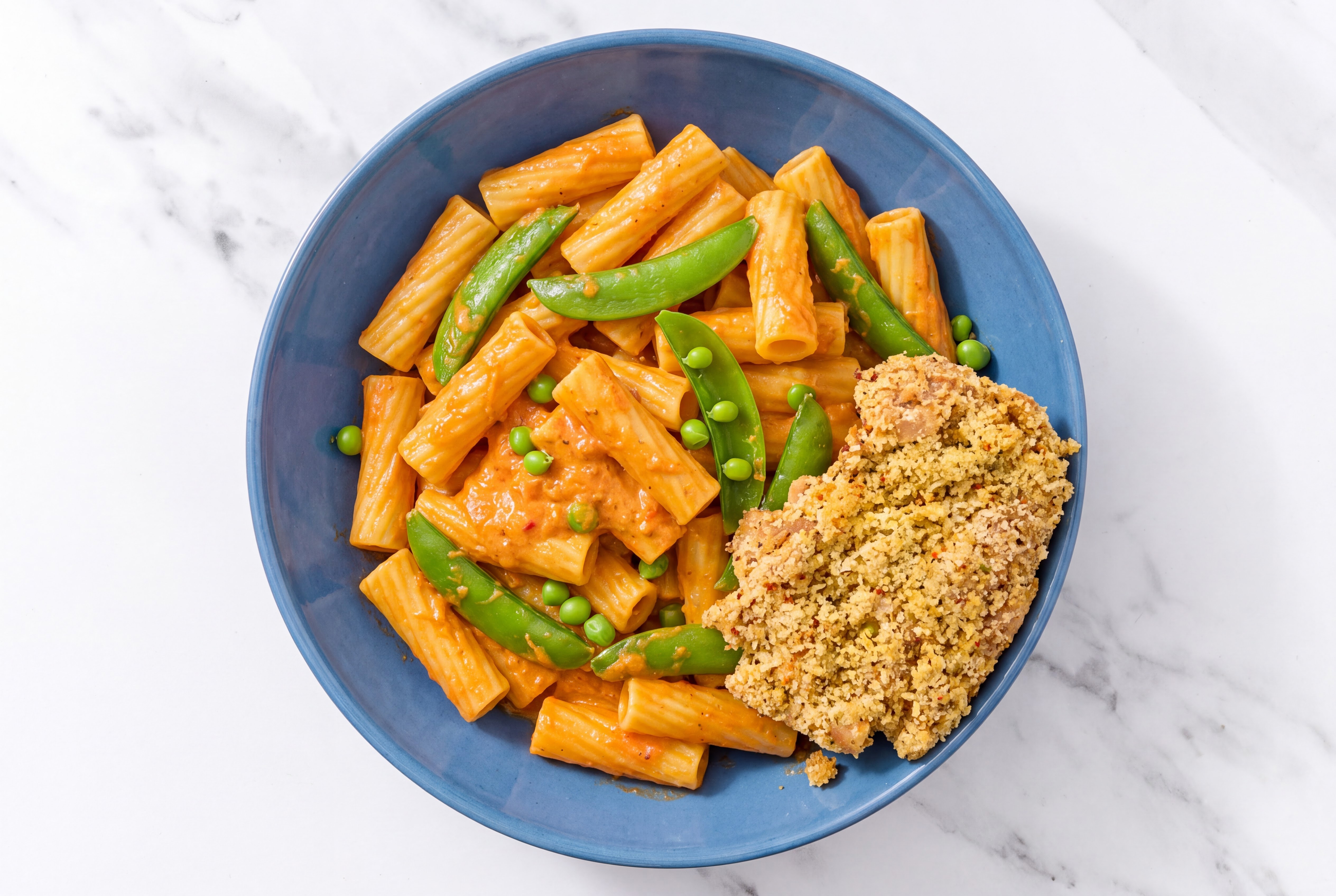 Crispy Garlic Chicken over Creamy Vodka Rigatoni with Snap Peas
