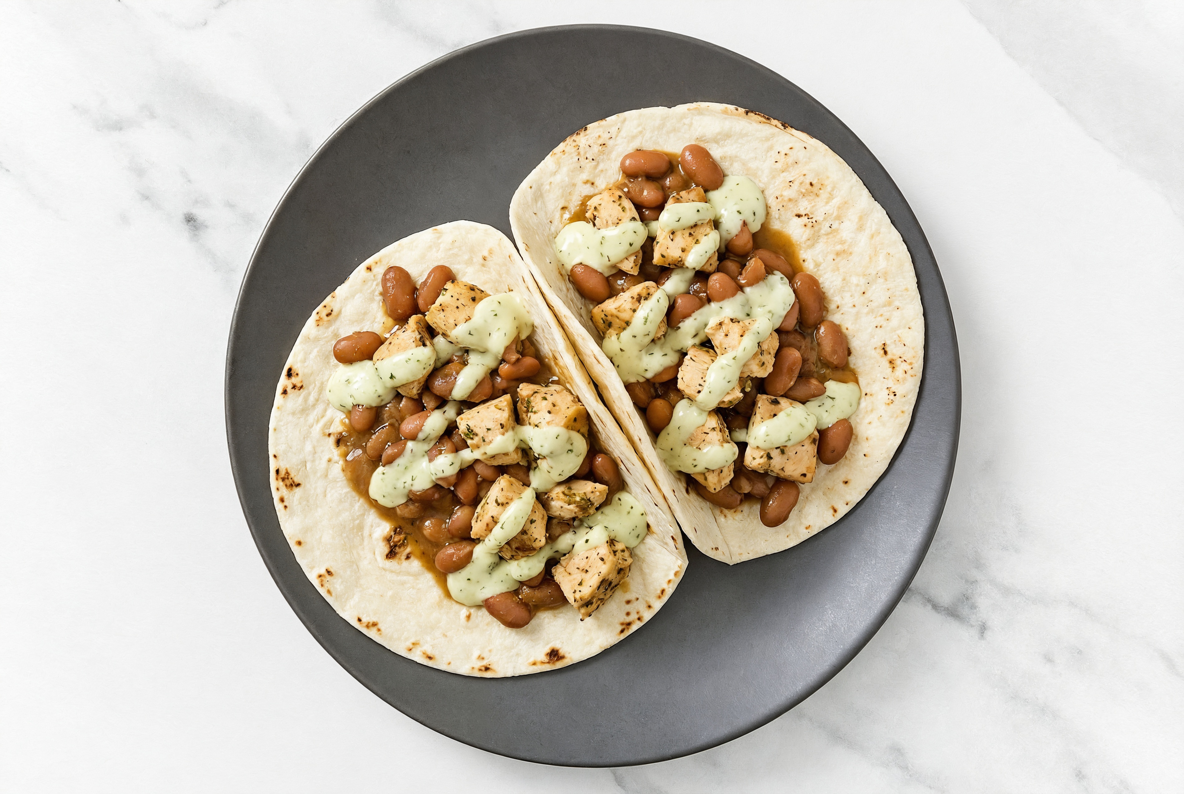  Garlic Chicken Tacos with Jalapeño Crema & Pinto Beans