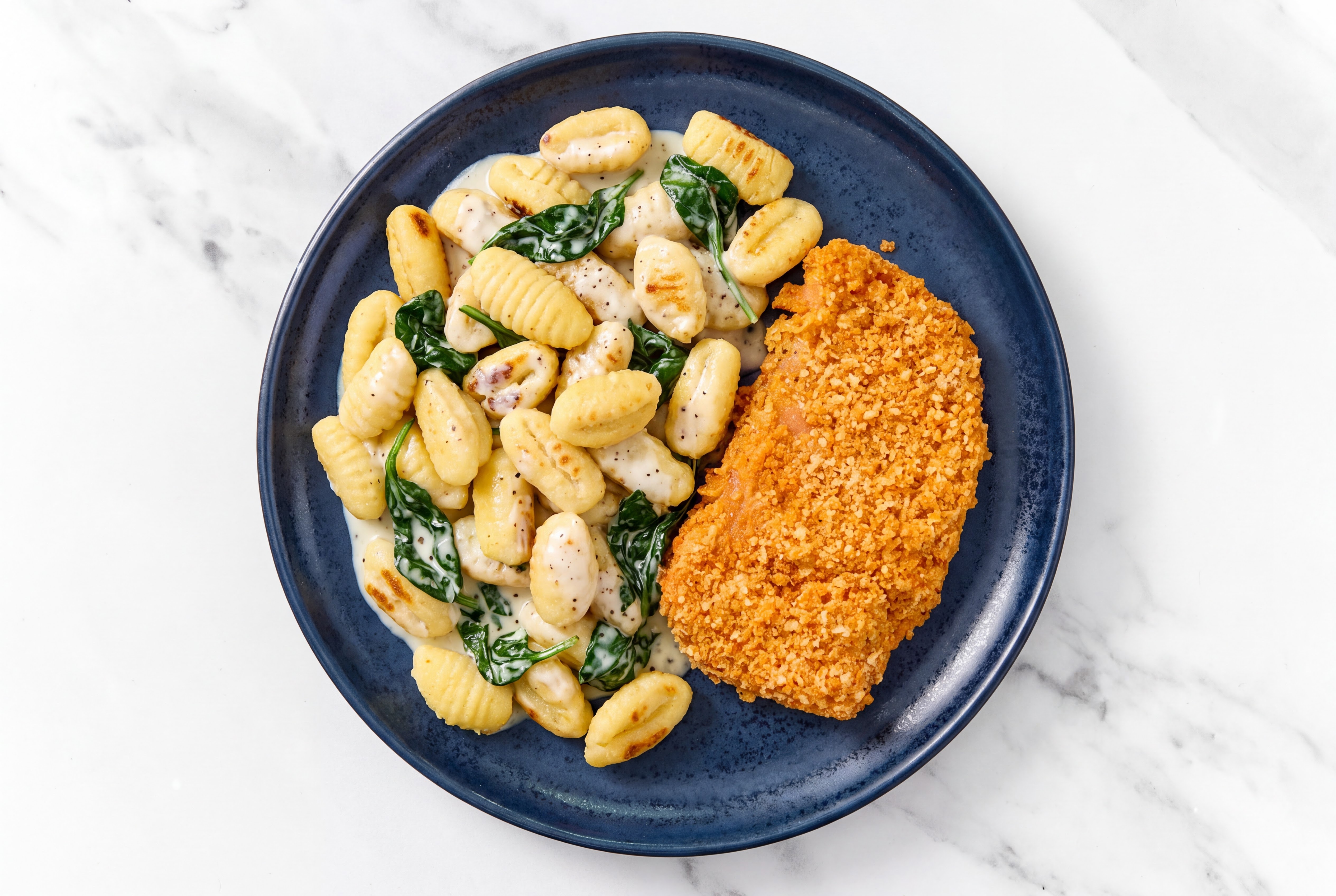 Crispy Hot Honey Chicken over Alfredo Gnocchi with Baby Spinach