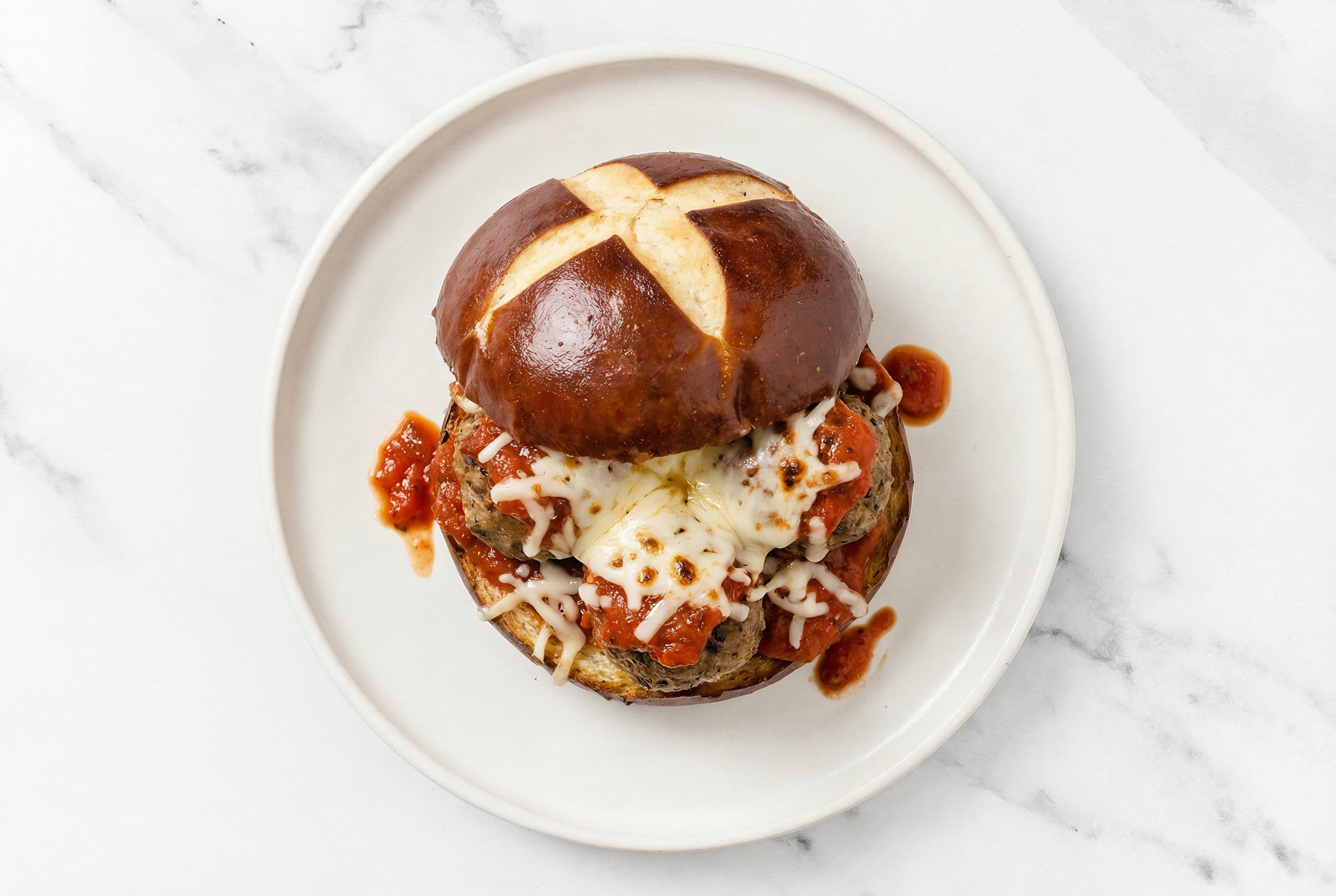 Cheesy Meatball Sub on a Pretzel Bun with Shredded Mozzarella Cheese