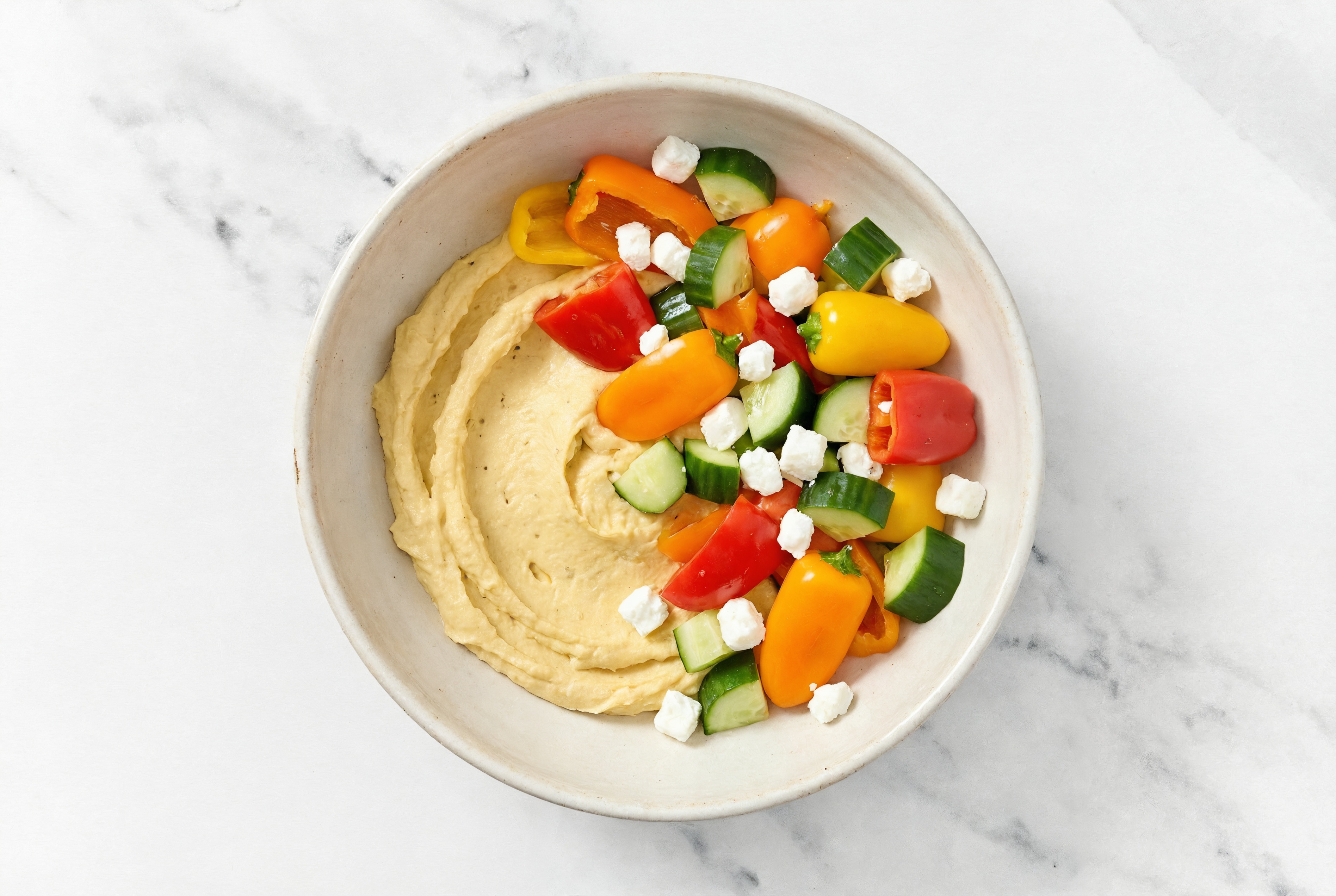 Crumbled Chevre Sweet Pepper Cucumber Bowl over Onion Hummus