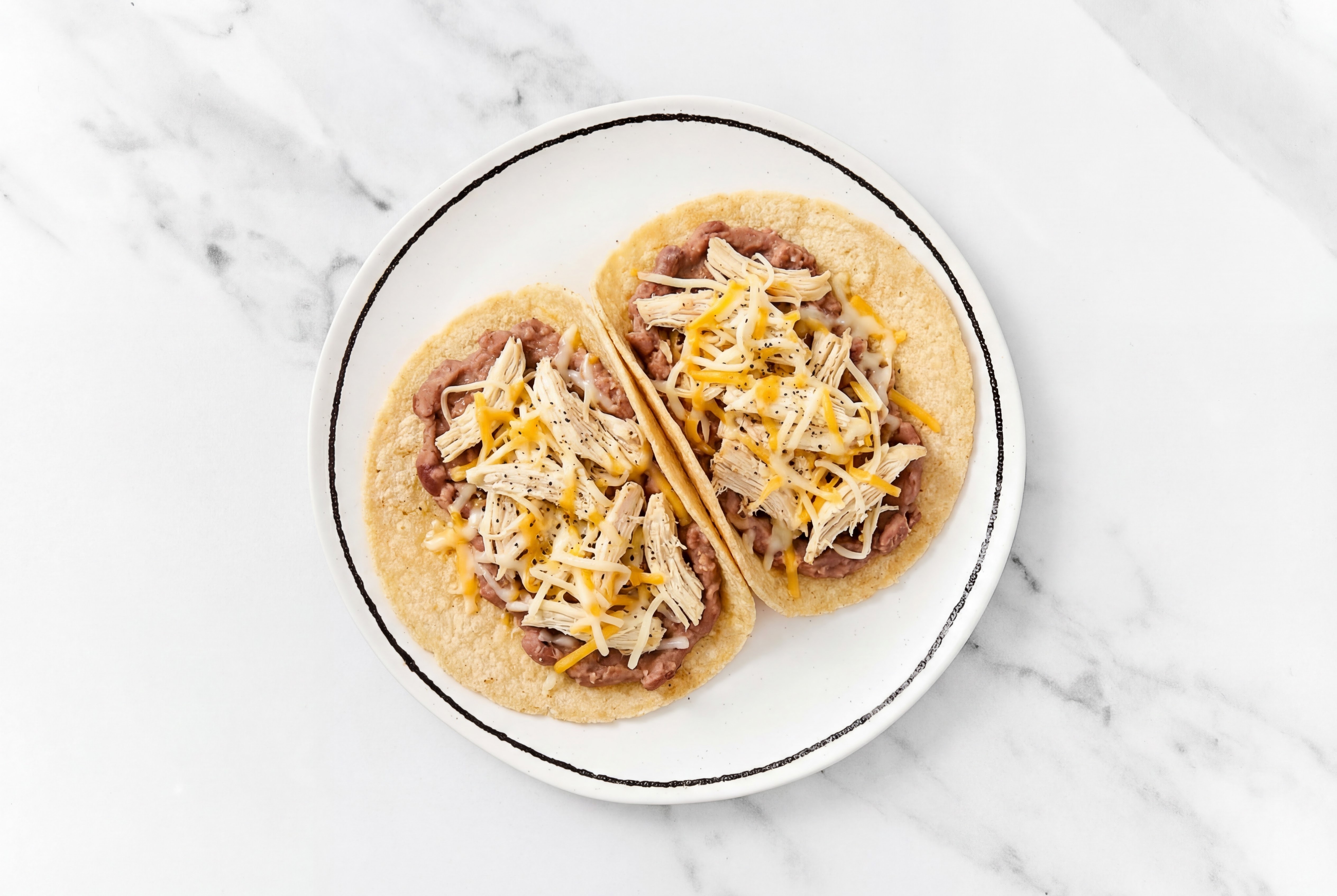 Pulled Chicken Tacos with Mexican Blend Cheese & Refried Red Beans