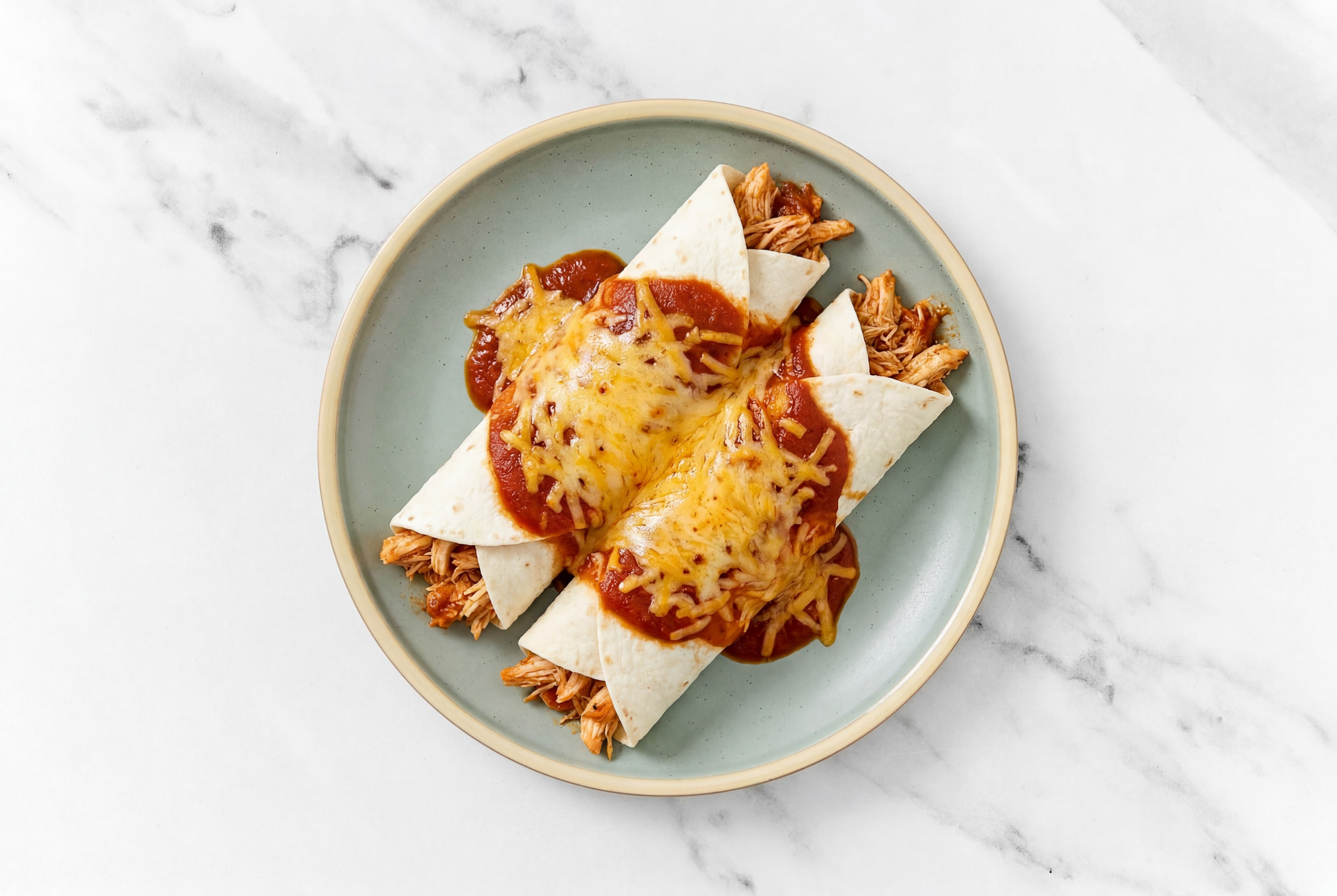 Savory Cheesy Pulled Chicken Enchiladas Rojas with Shredded Sharp Cheddar Cheese