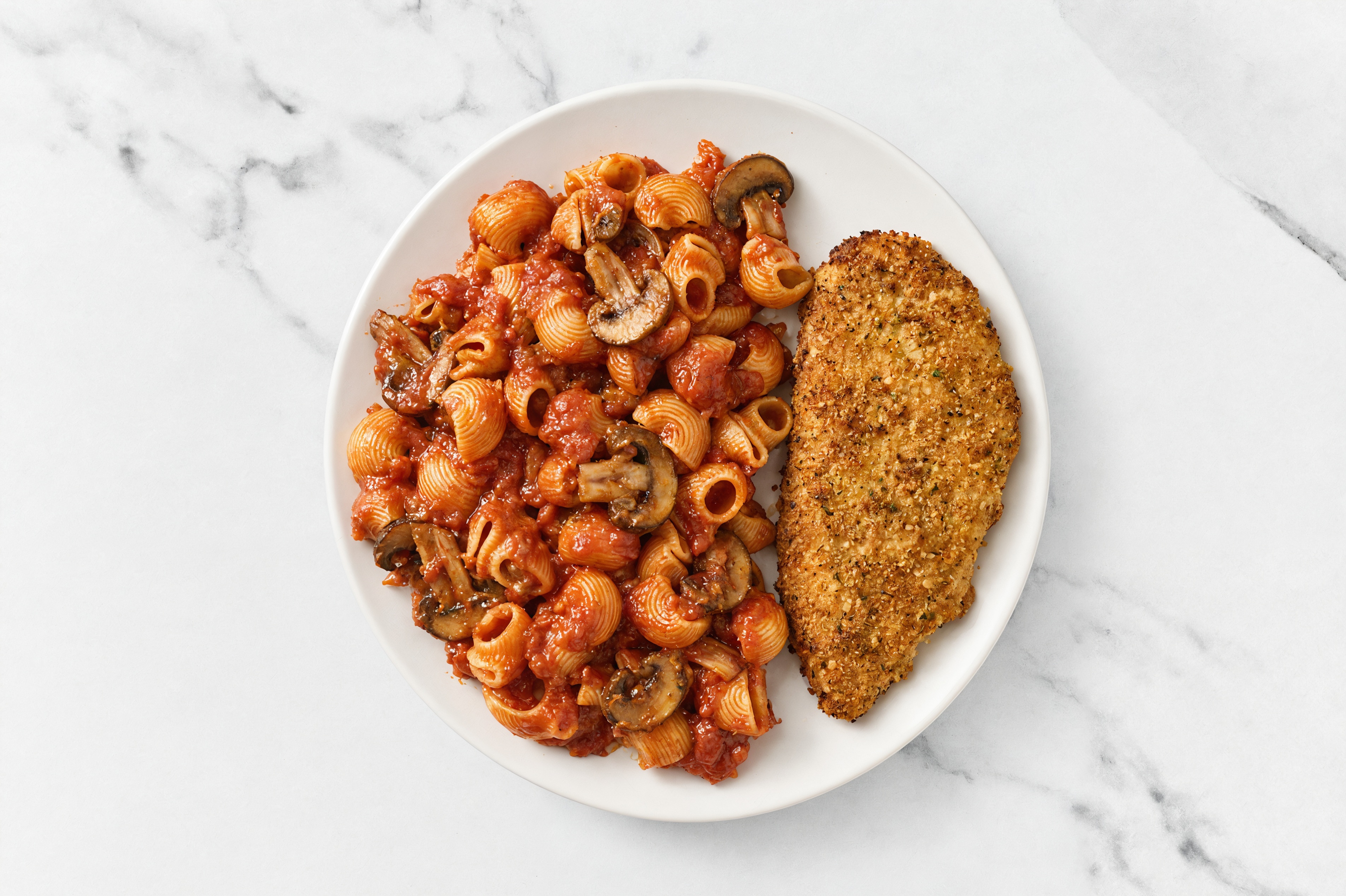 Crispy Garlic Chicken over Marinara Chiocciole Pasta with Baby Bella Mushrooms