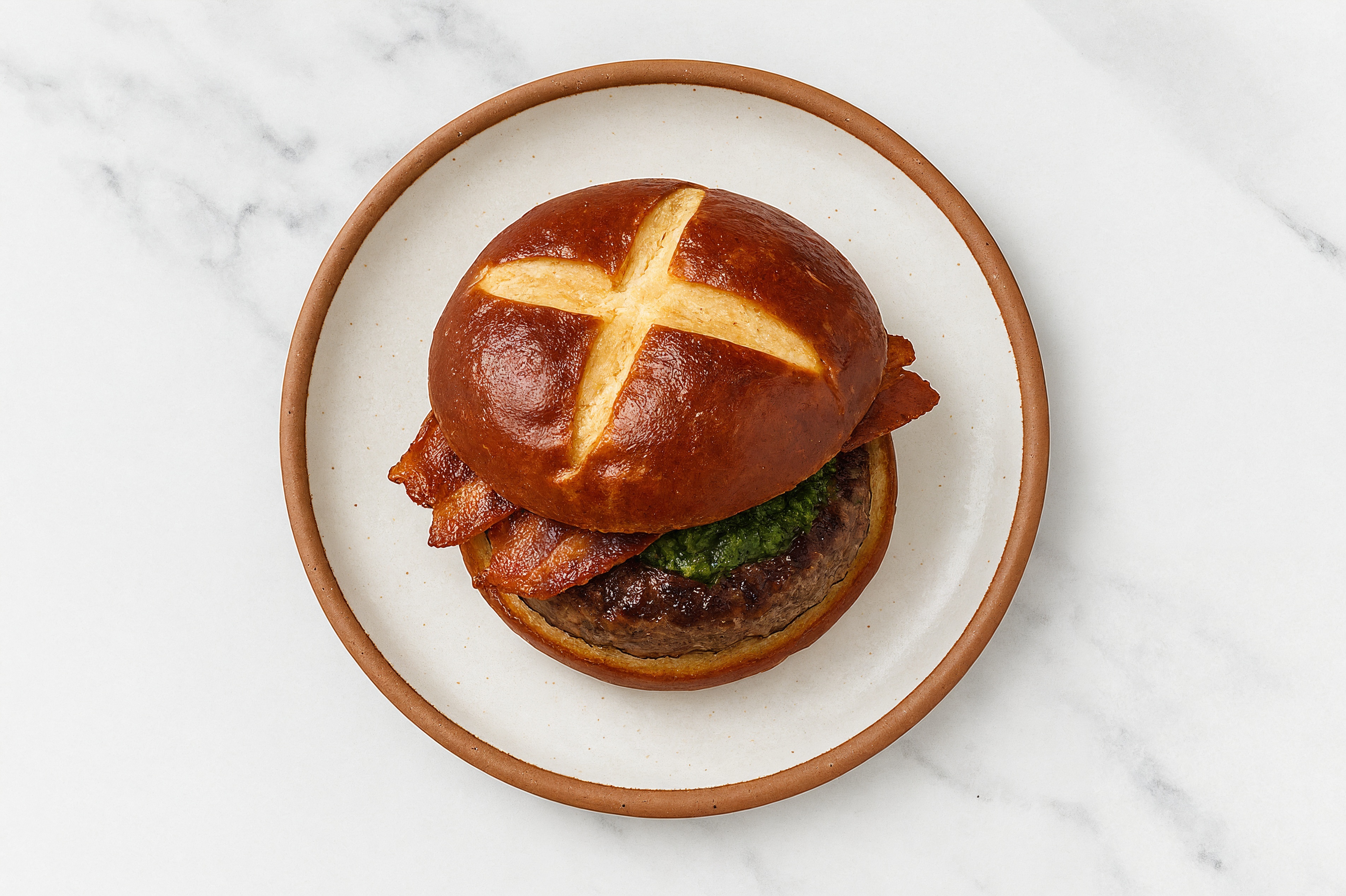 Lamb Burger on Pretzel with Spinach Pesto & Applewood Smoked Pork Bacon