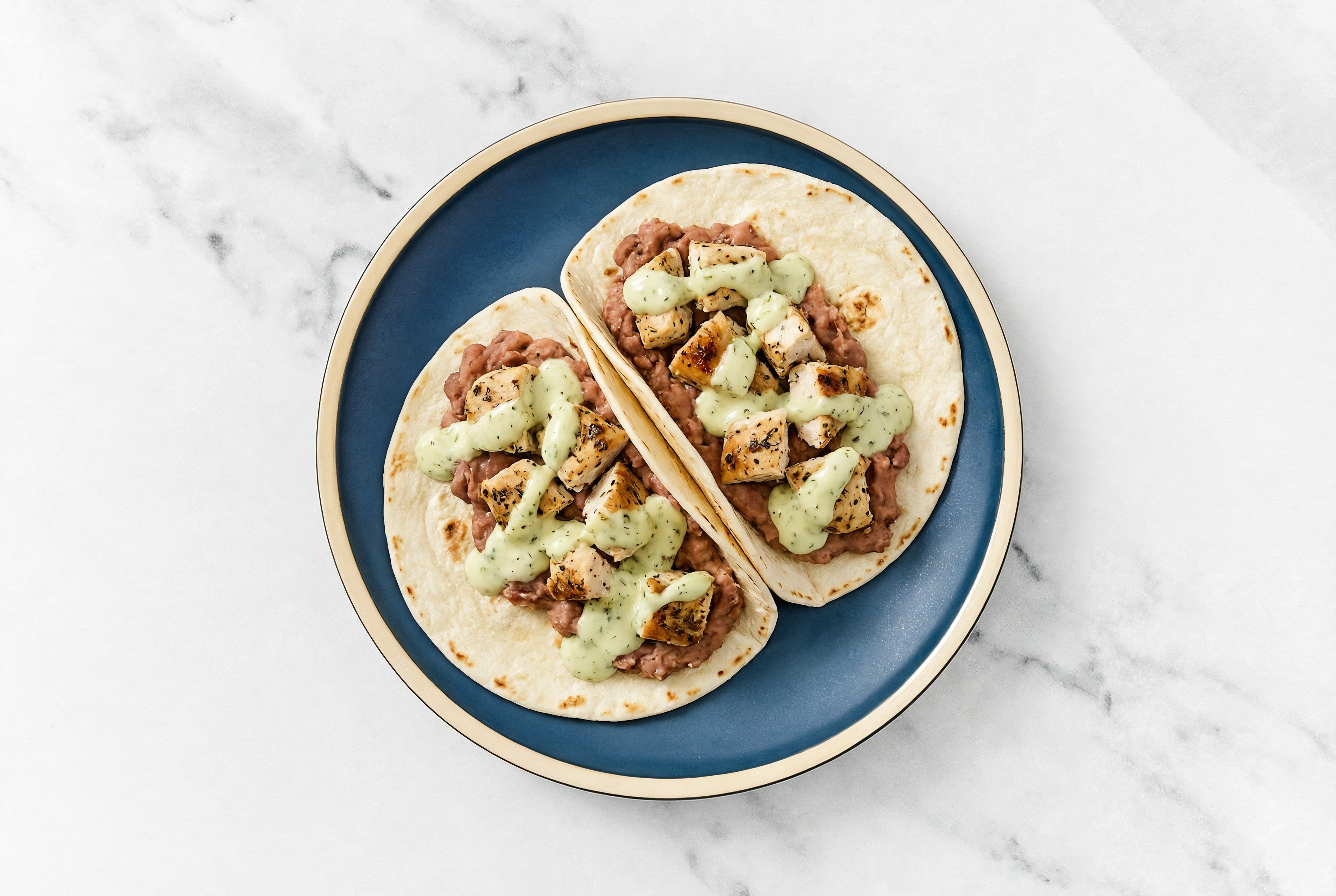  Garlic Chicken Tacos with Jalapeño Crema & Refried Red Beans