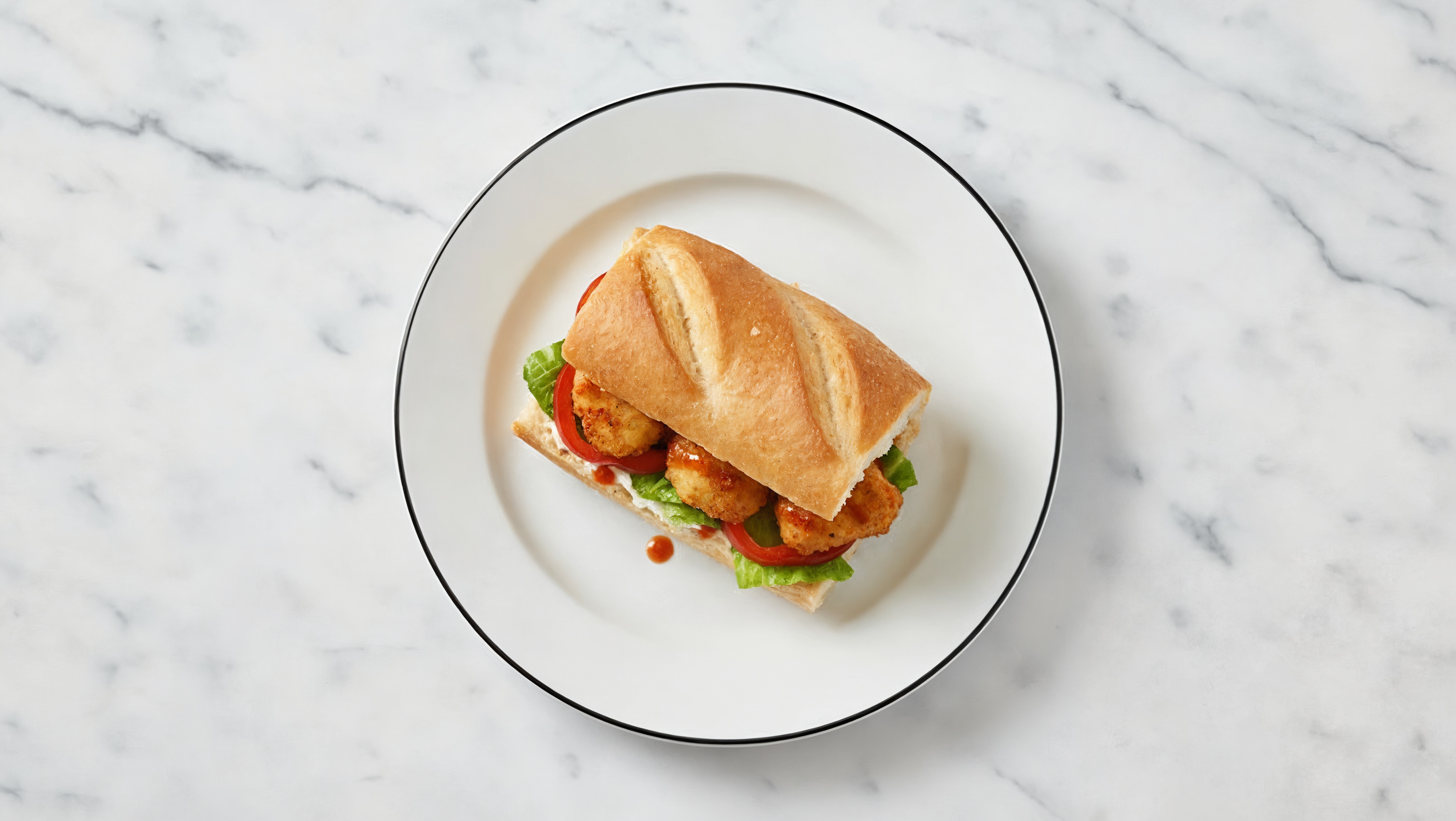 Breaded Chicken with Sriracha Hot Sauce on Baguette with Red Pepper