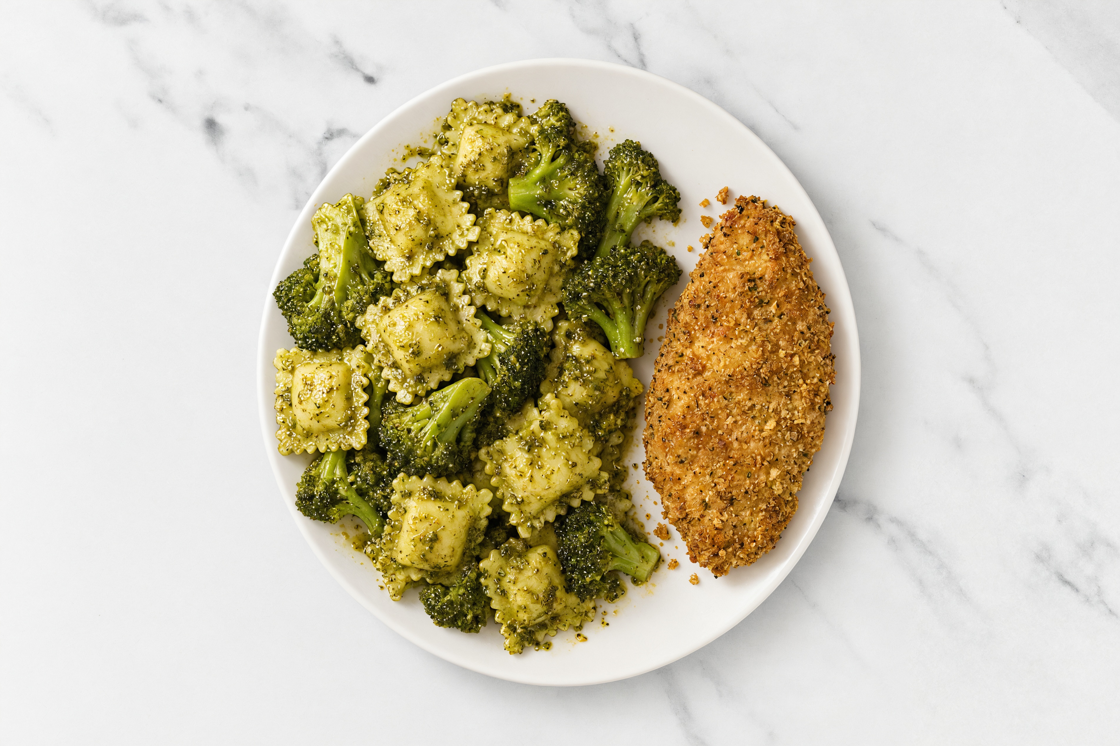 Crispy Garlic Chicken over Pesto Ravioli with Broccoli