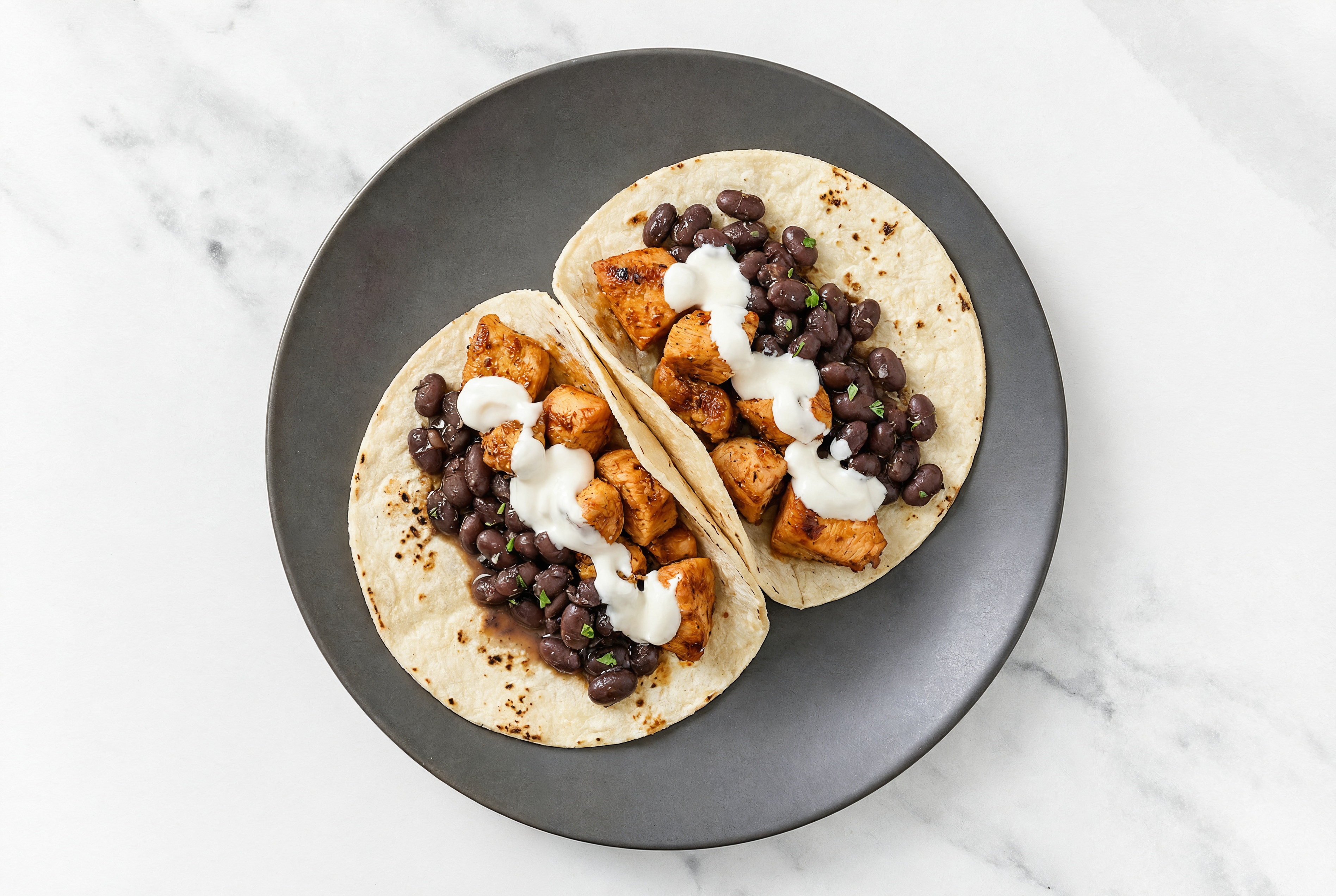 Hearty Chipotle Chicken Tacos with Crema & Spiced Beans