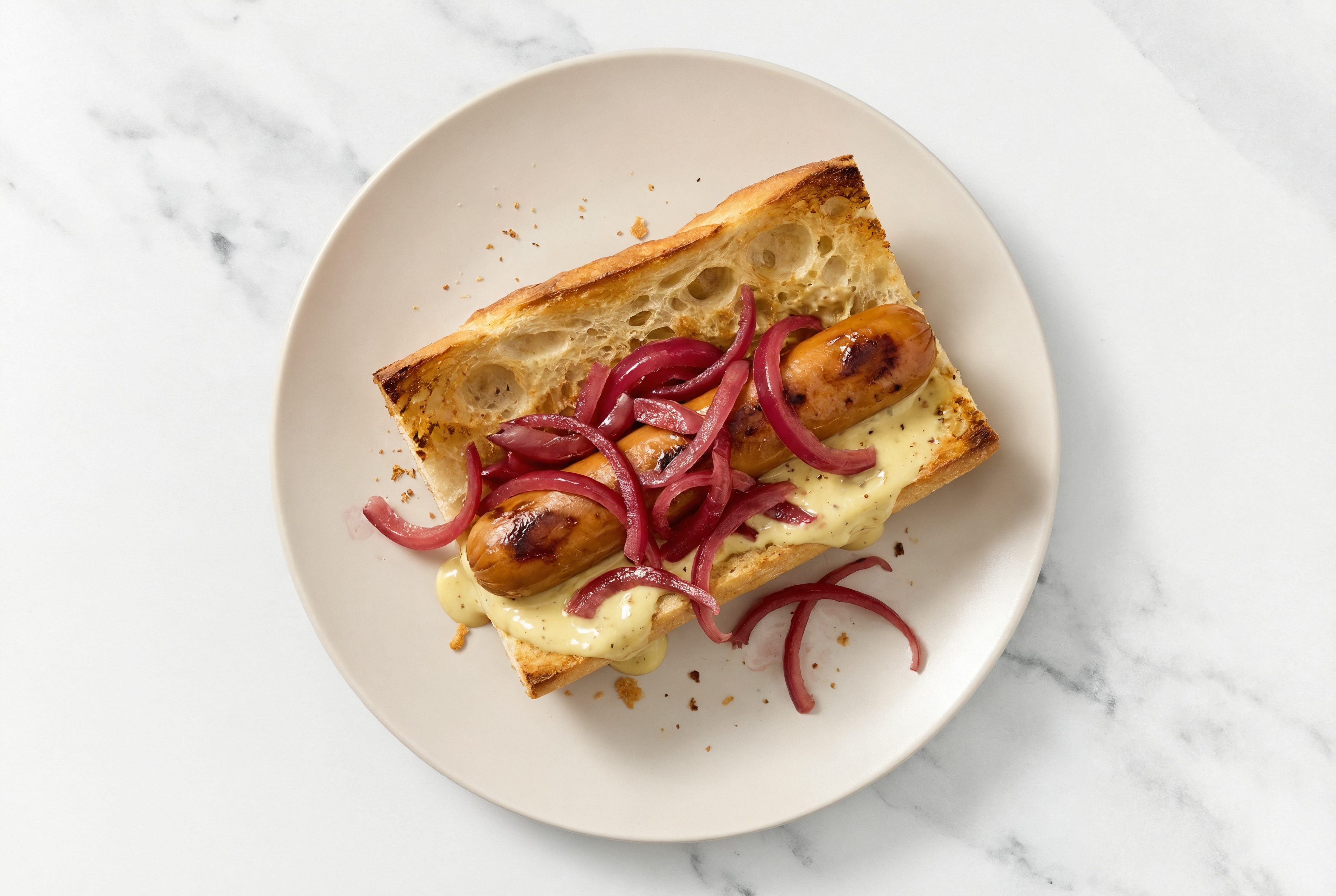 Pickled Red Onion Smart Dog with Honey Musard Garlic Sauce on Baguette