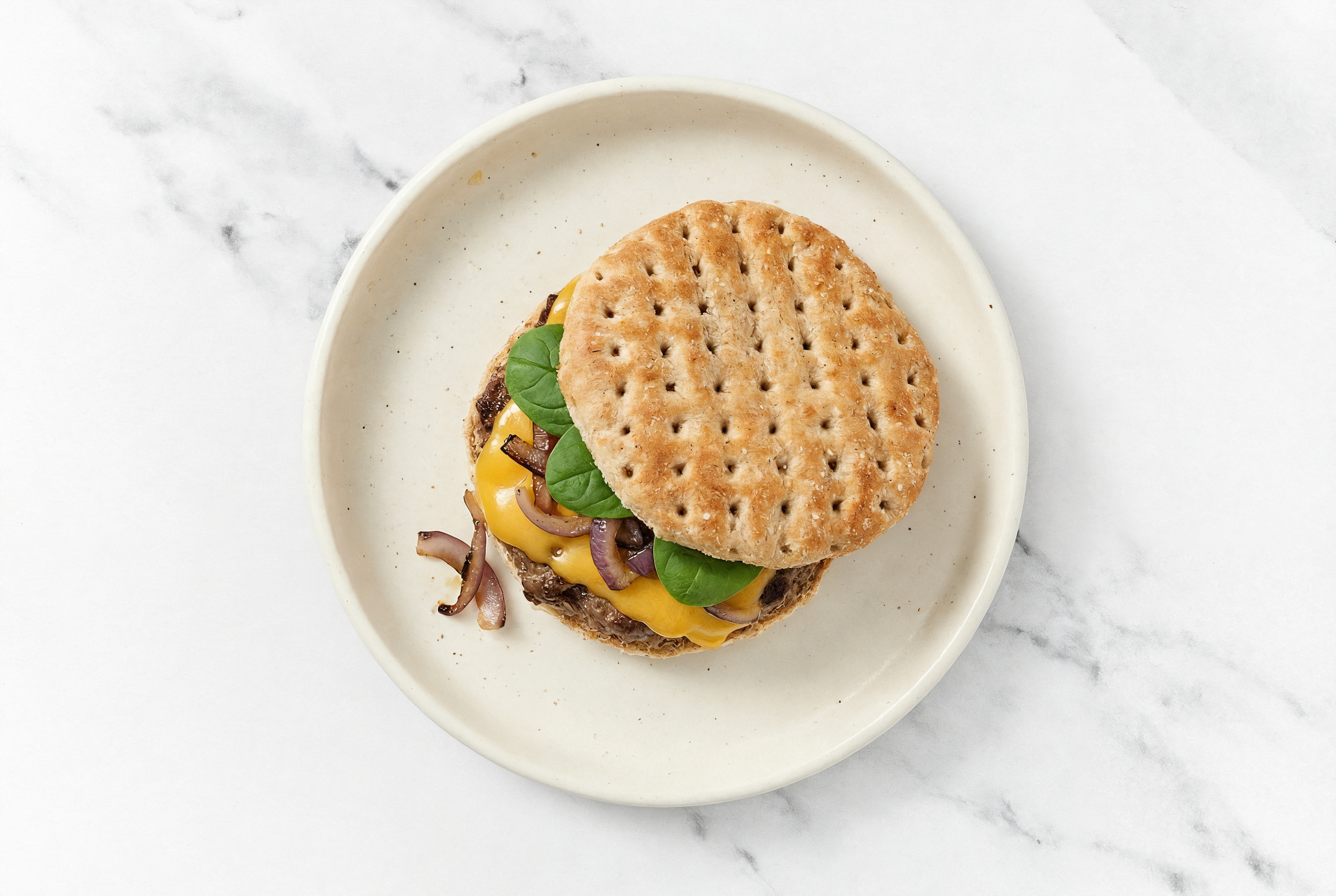 Hearty OneBun Multigrain Grass-Fed Cheeseburger with Sautéed Onions