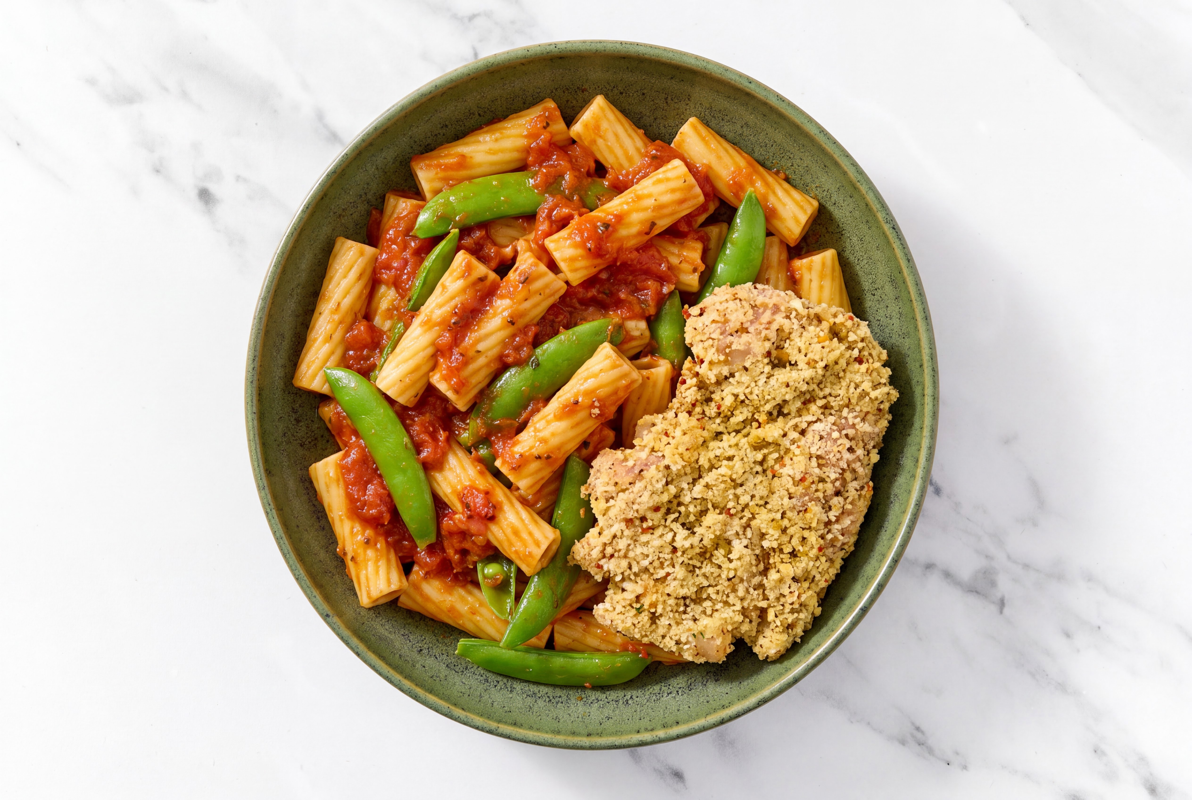 Crispy Garlic Chicken over Marinara Rigatoni with Snap Peas