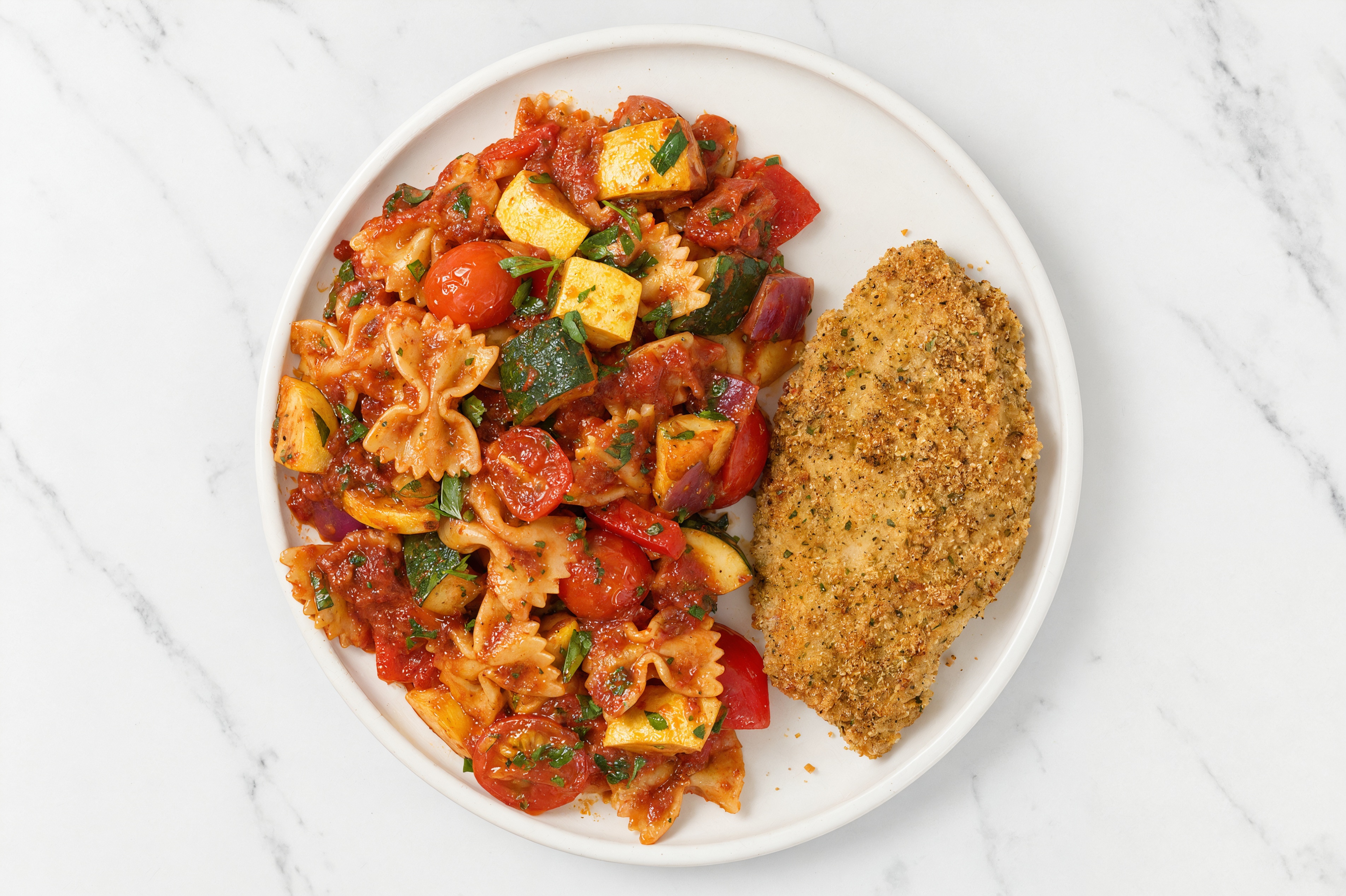 Crispy Garlic Chicken over Marinara Farfalle with Mixed Veggies