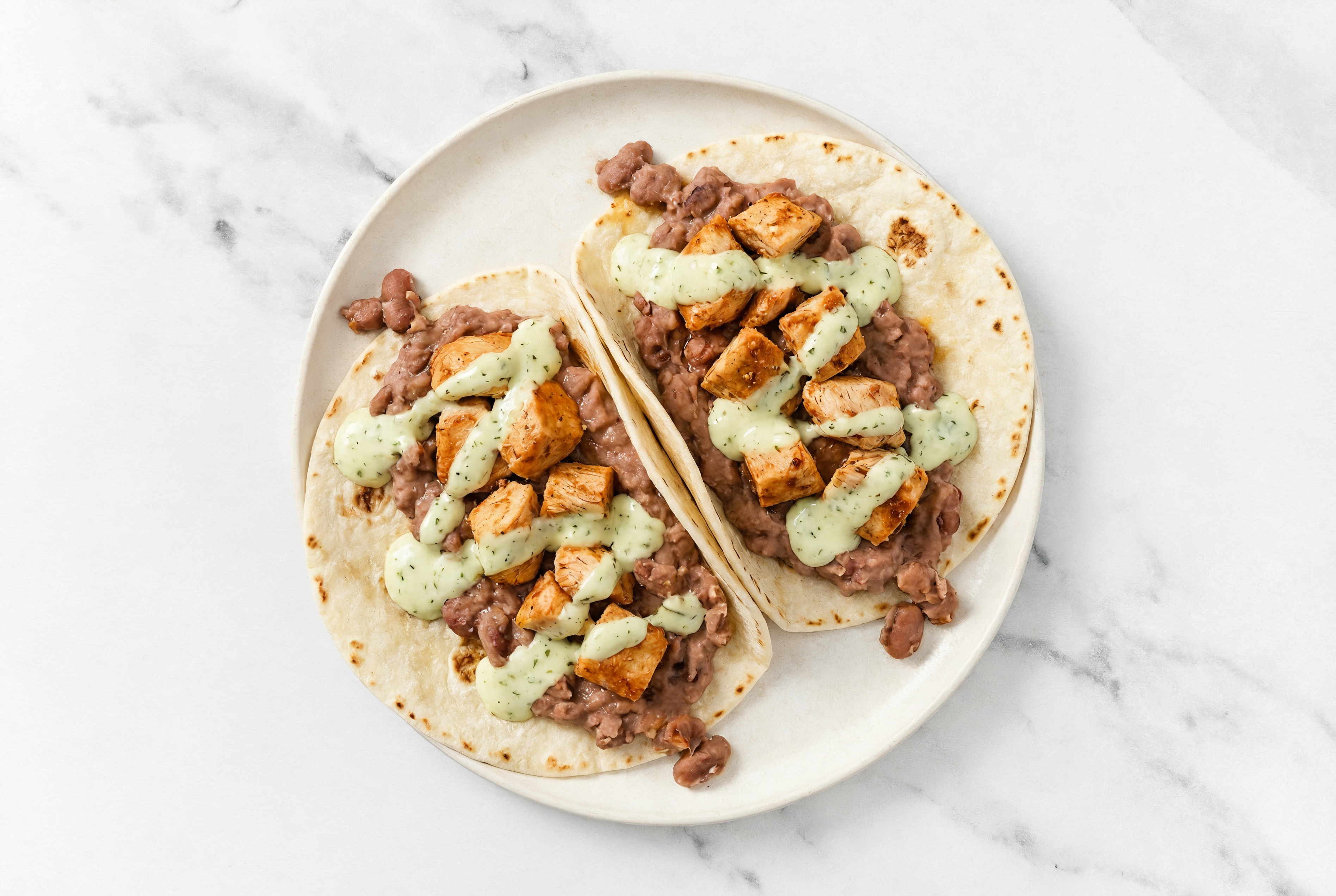 Chipotle Chicken Tacos with Jalapeño Crema & Refried Red Beans