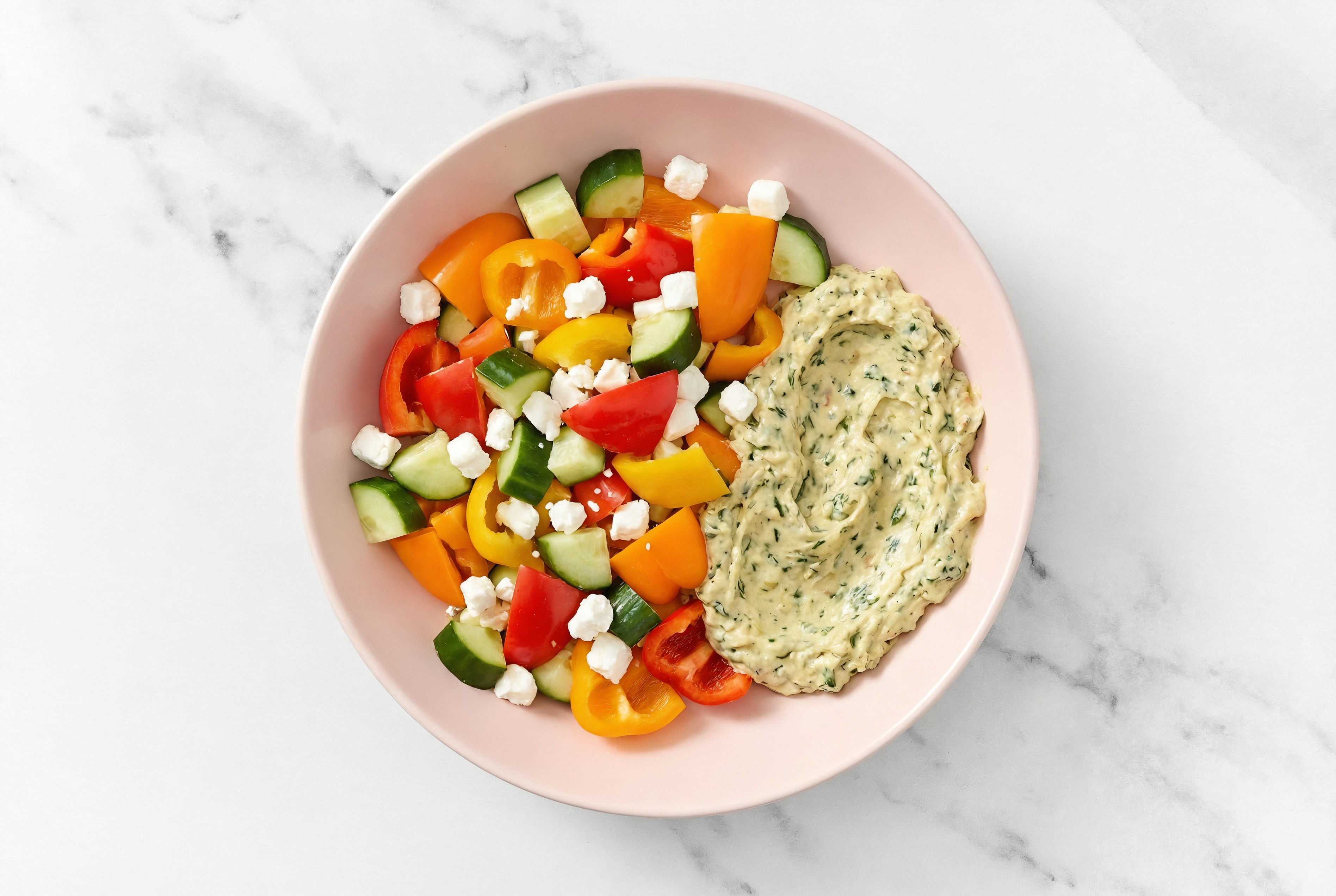 Crumbled Chevre Sweet Pepper Cucumber Bowl over Spinach Artichoke Dip