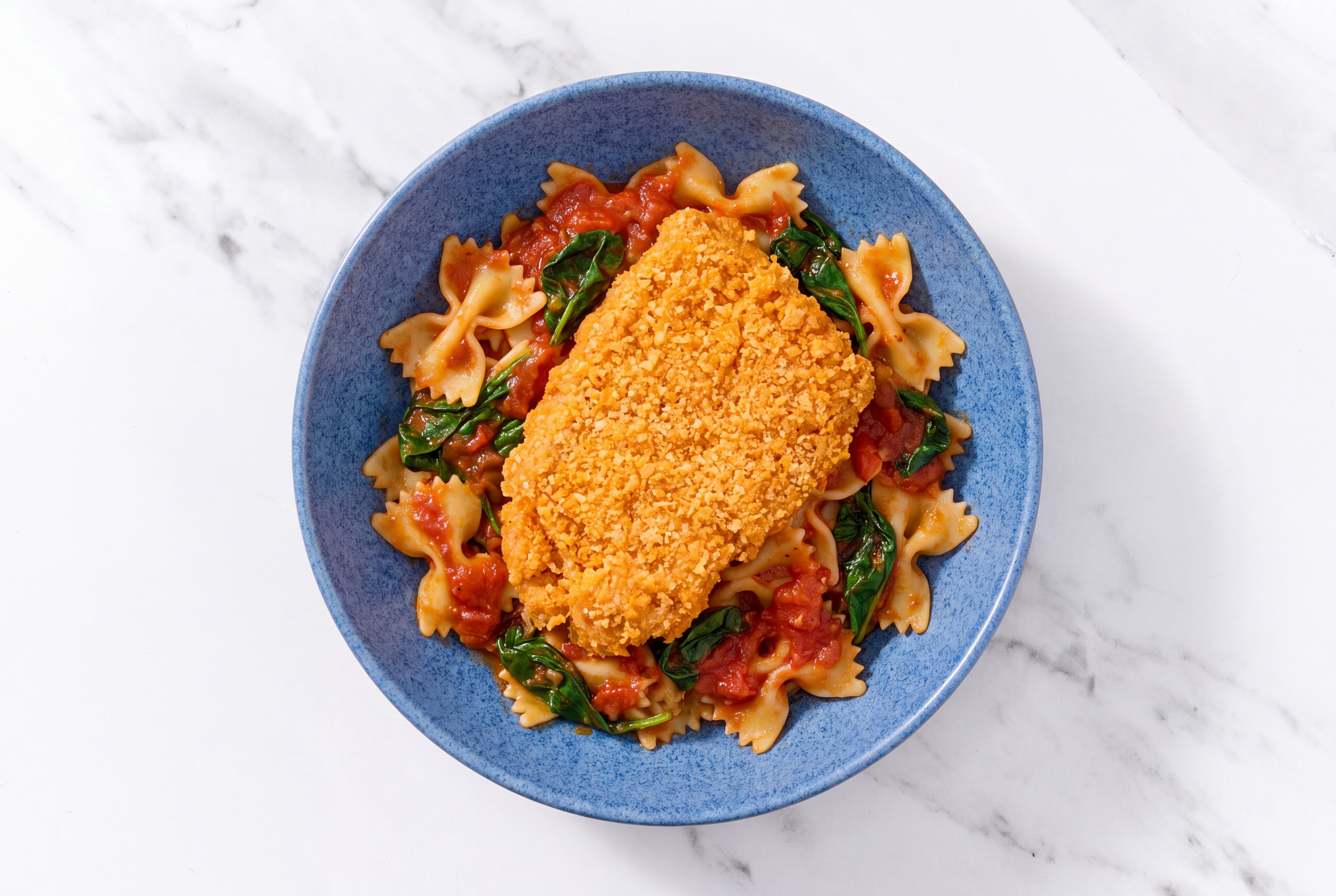 Crispy Hot Honey Chicken over Marinara Farfalle with Baby Spinach