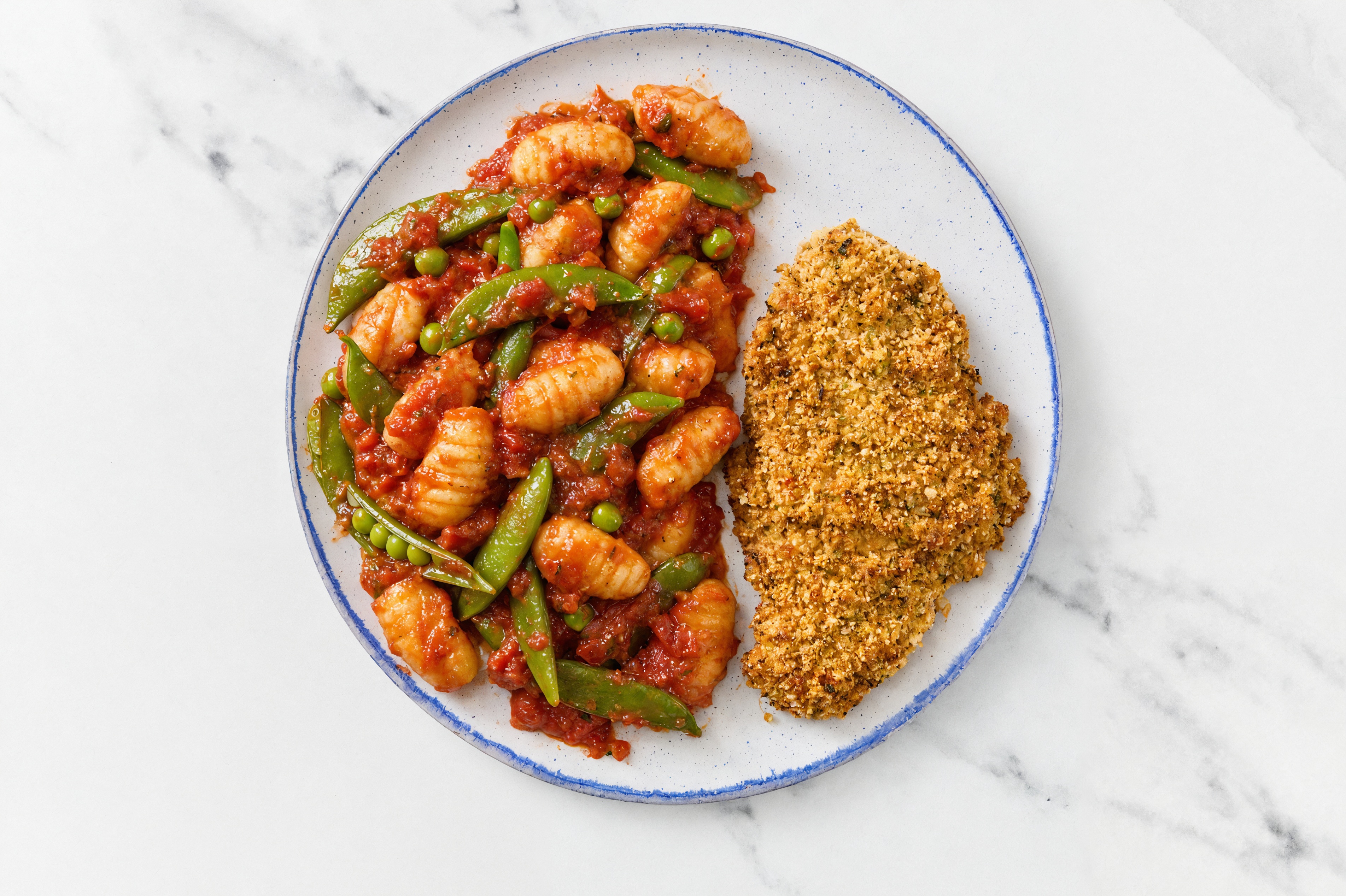 Crispy Garlic Chicken over Marinara Gnocchi with Snap Peas
