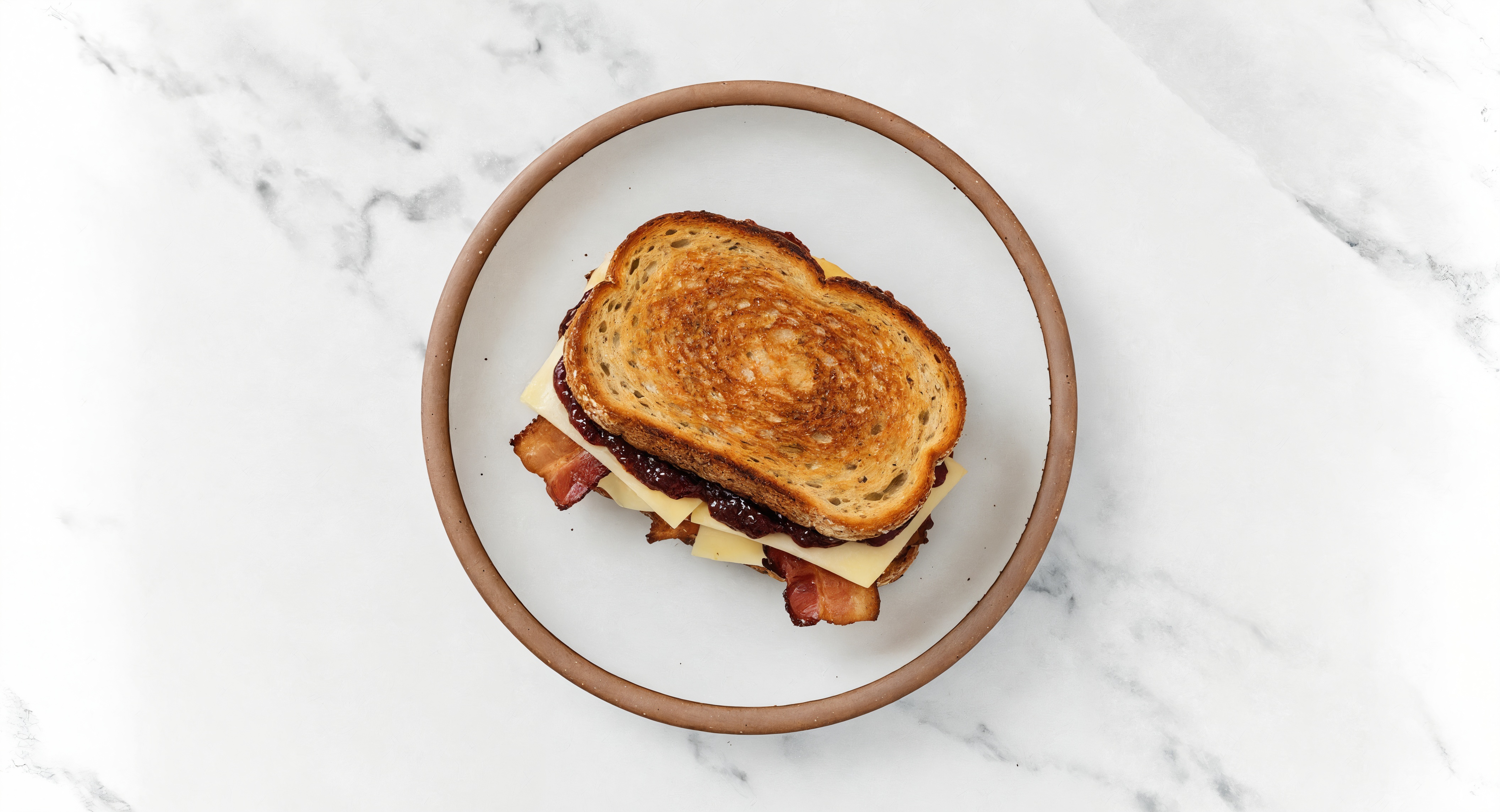 Applewood Smoked Pork Bacon, Gouda + Strawberry Jam Multgrain Sourdough Grilled Cheese