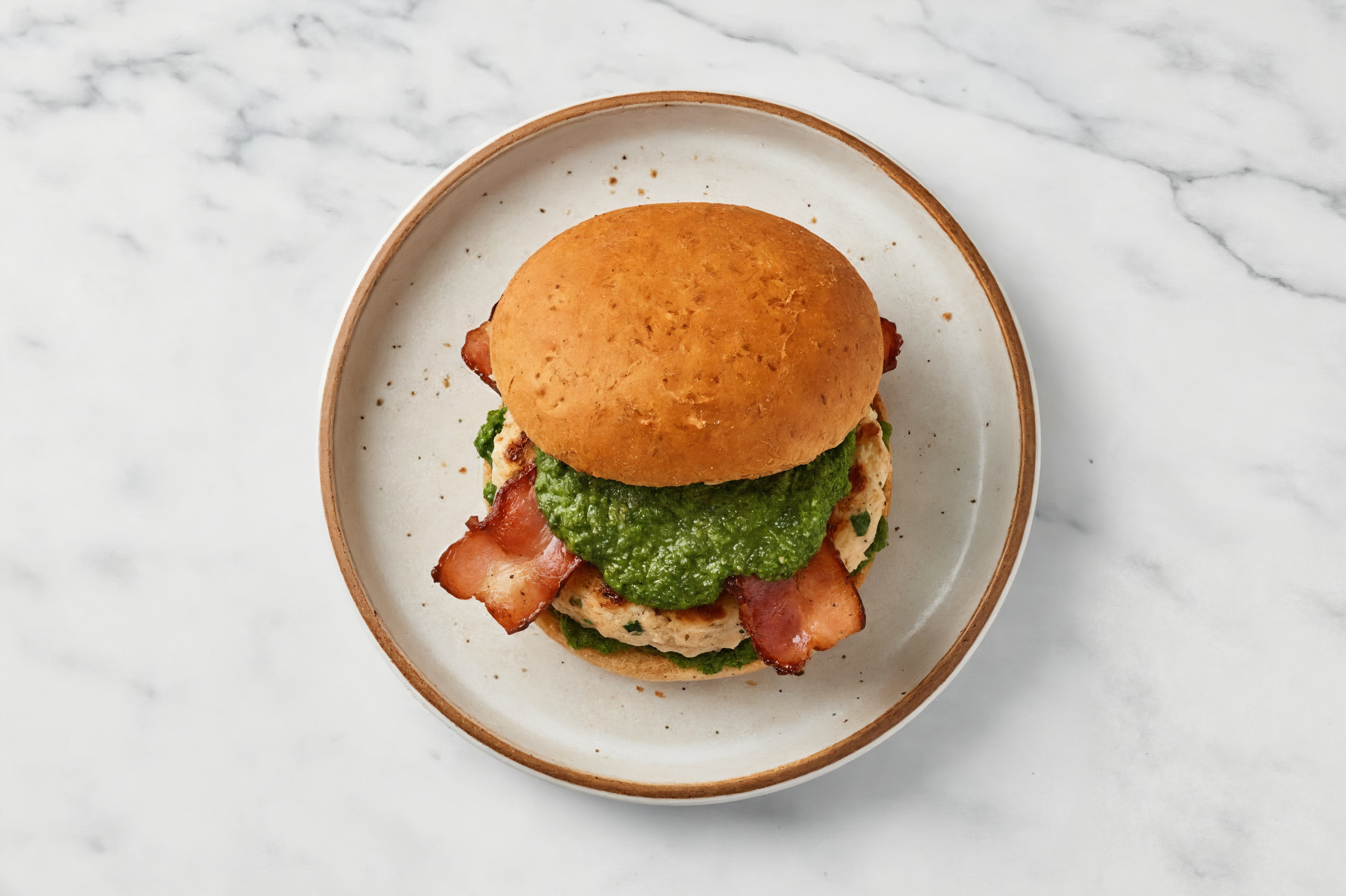 Garlic Chicken Burger on Sprouted Grain with Spinach Pesto & Turkey Bacon