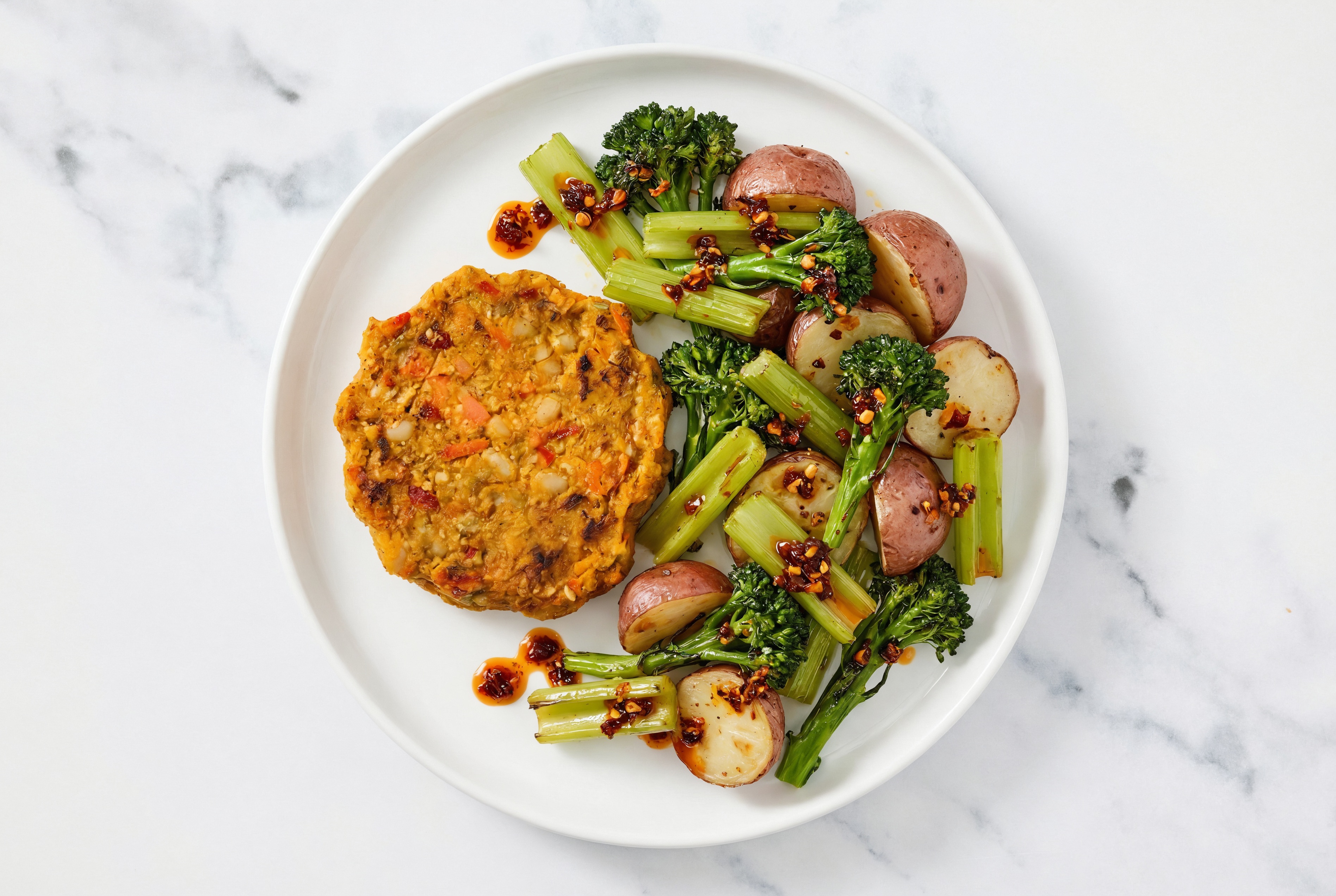 Roasted Celery + Red Potatoes with Chili Crisp Lime, Veggie Sweet Potato Burger Patties Plate