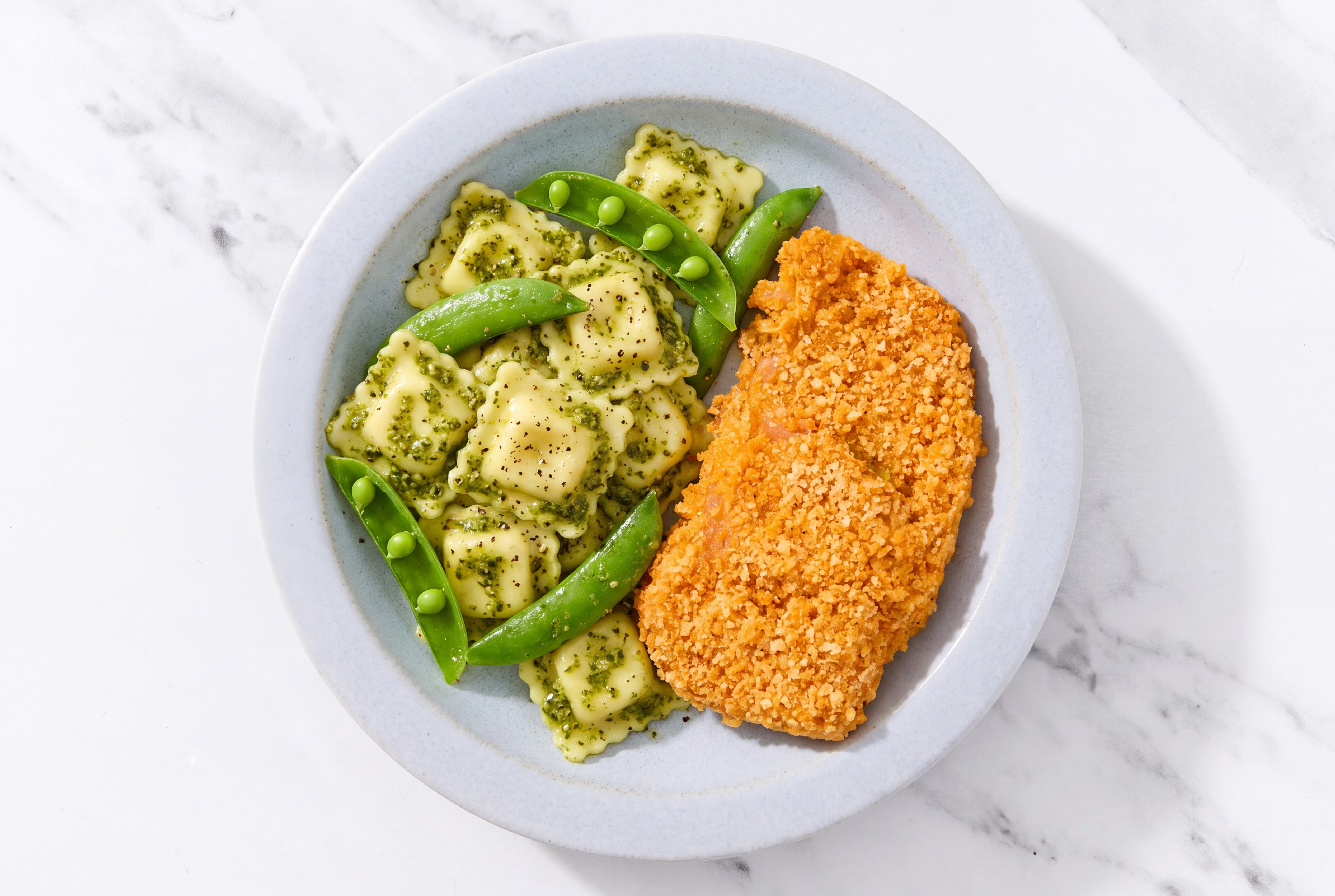 Crispy Hot Honey Chicken over Pesto Ravioli with Snap Peas